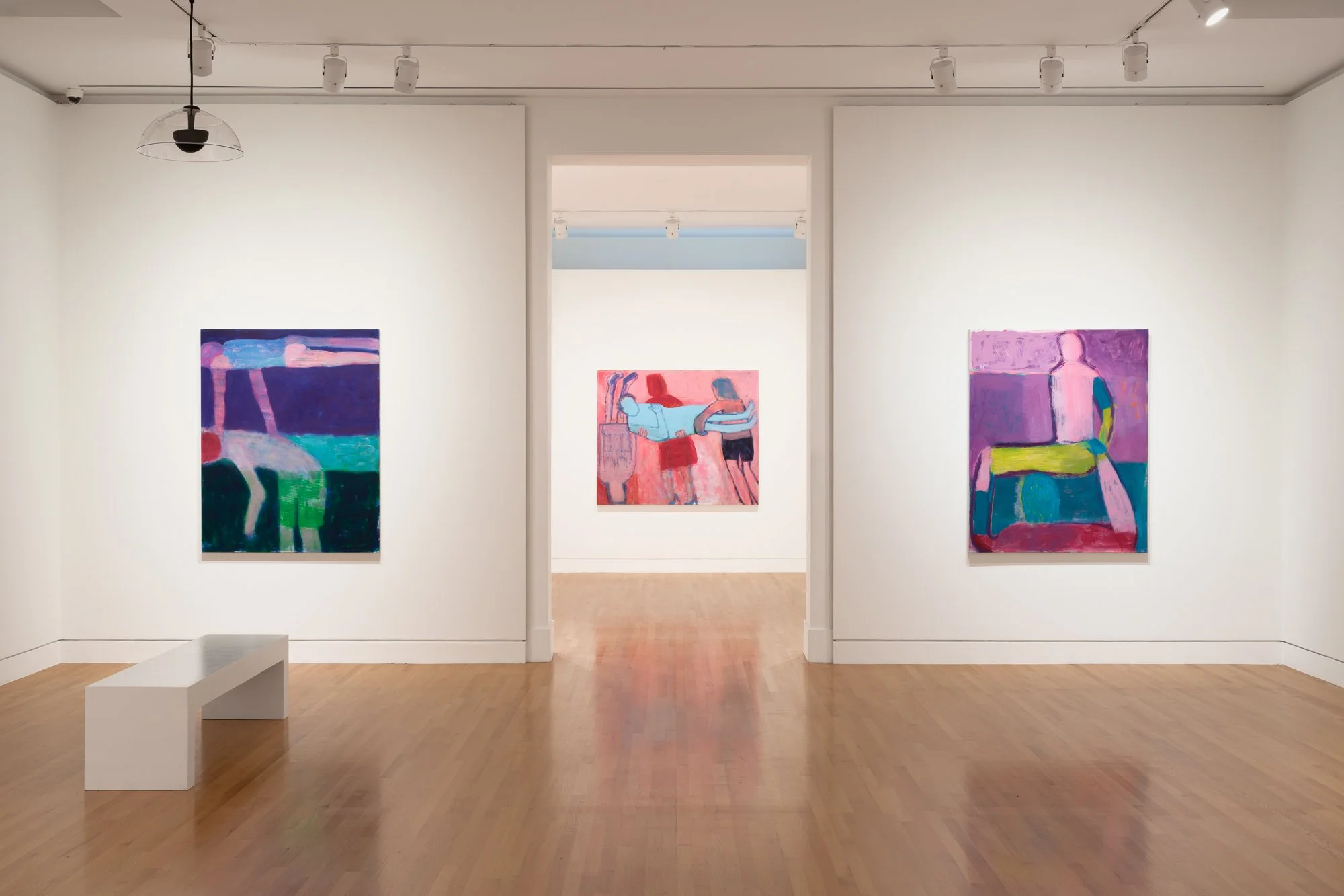 3 colorful paintings in a gallery
