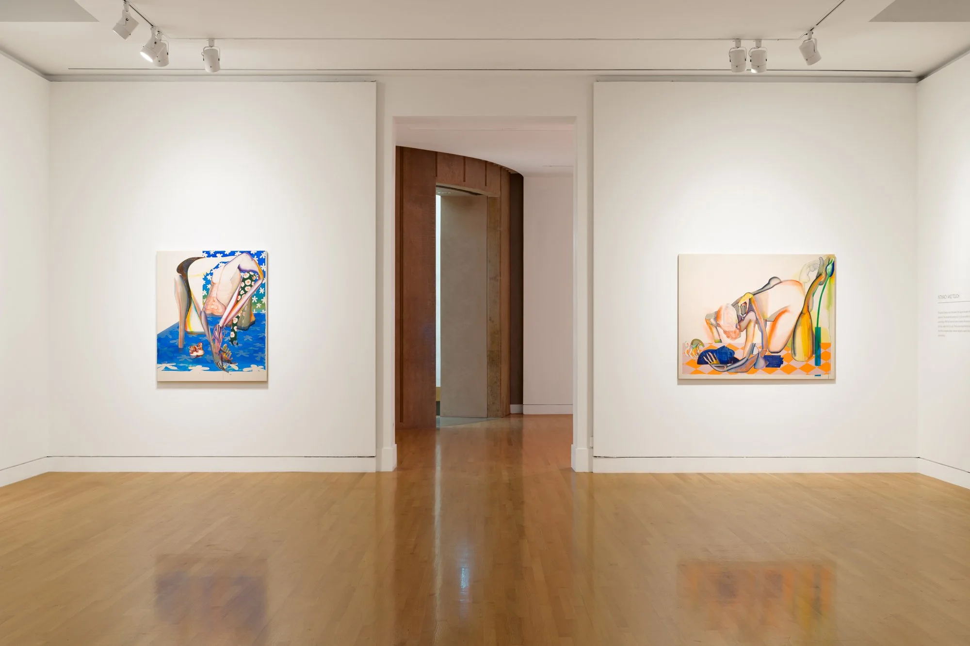 two abstract paintings in a gallery