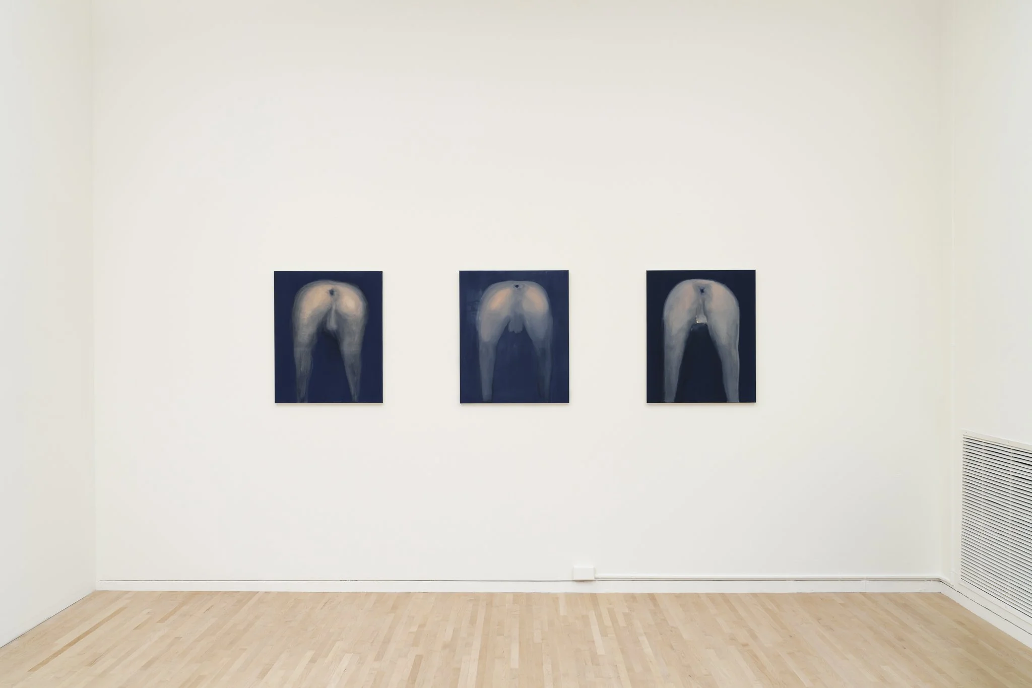 three paintings of butts on the wall