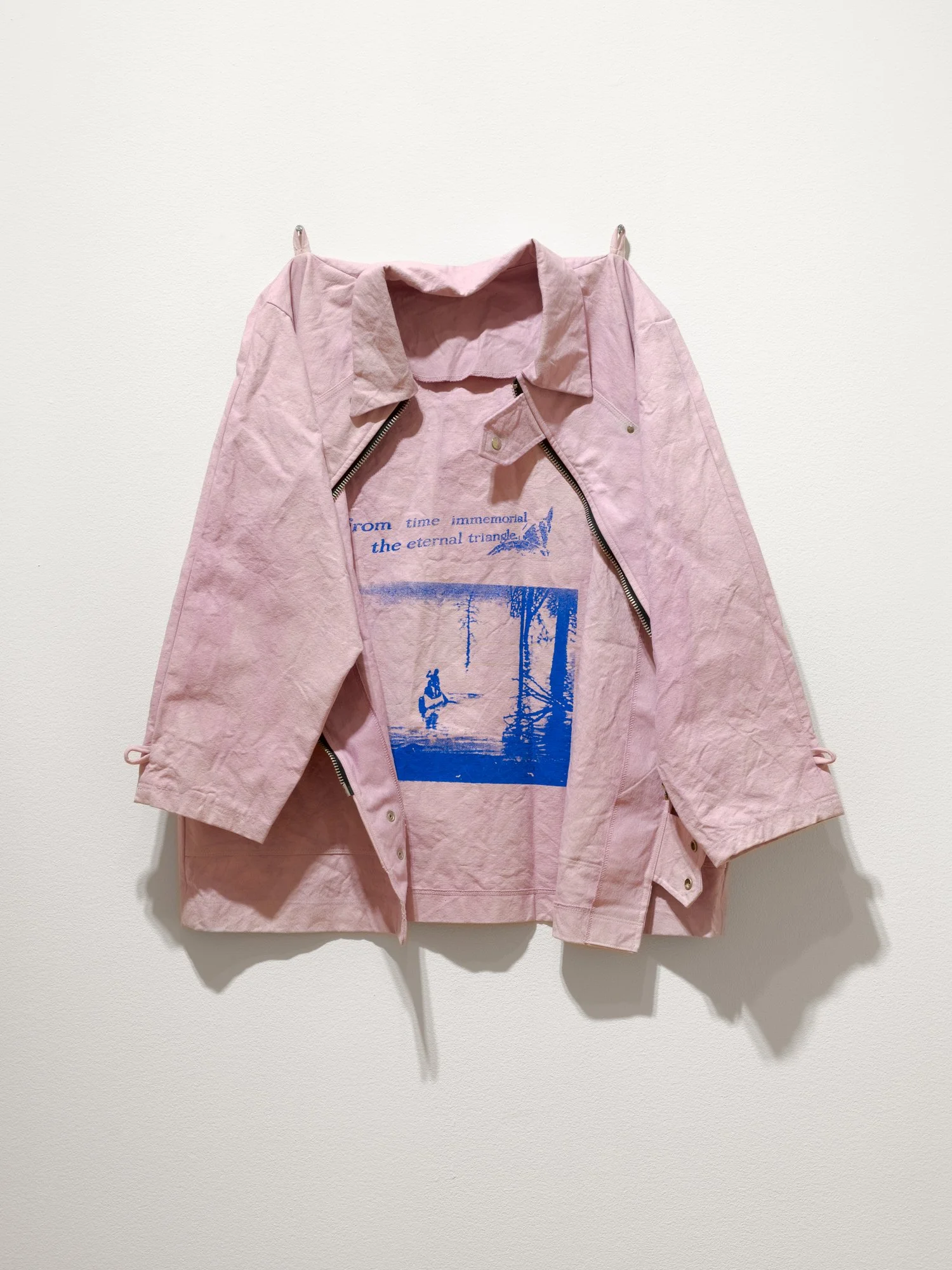a pink jacket with blue image and text printed on
