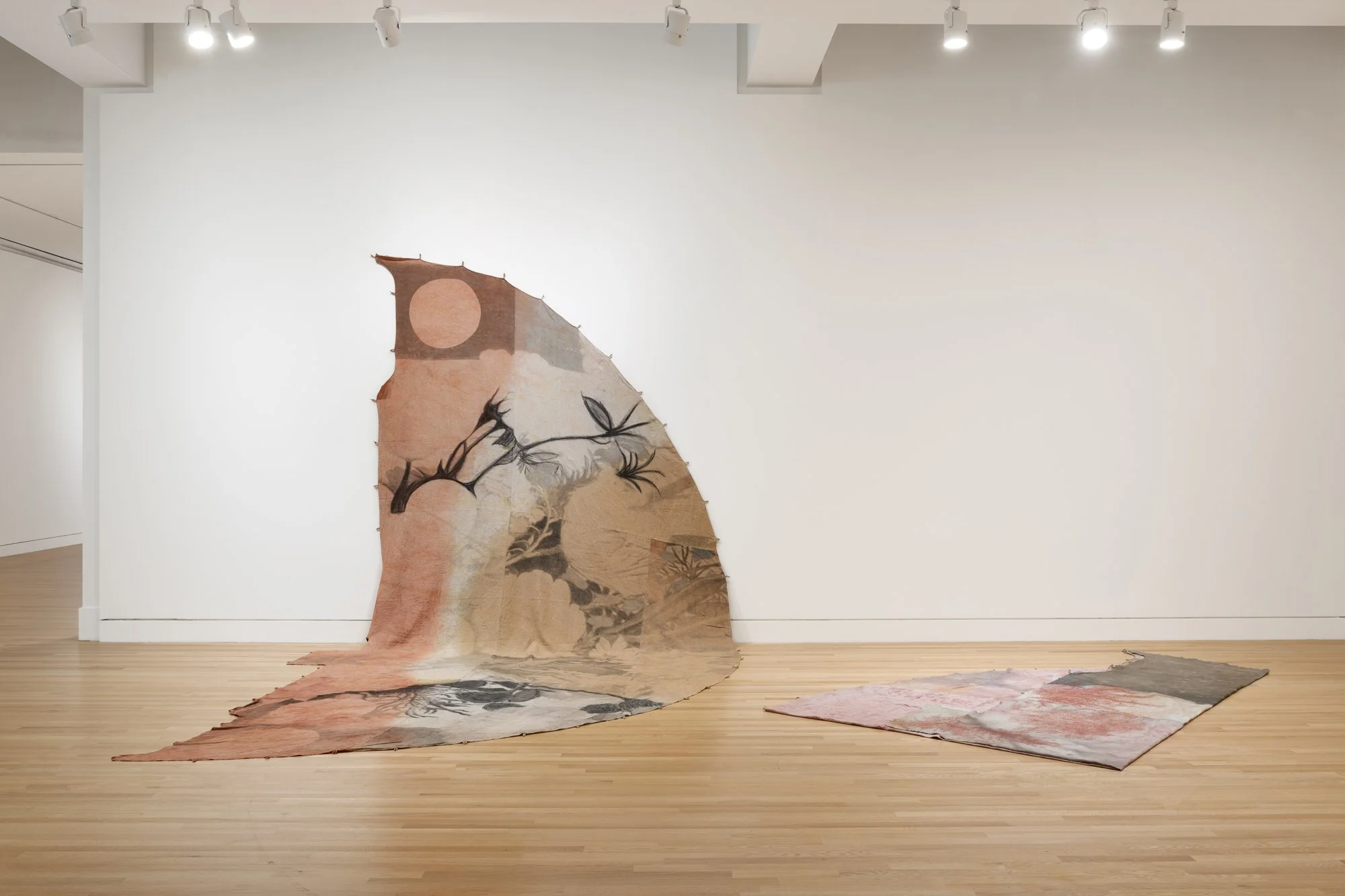 various large textile works in a gallery