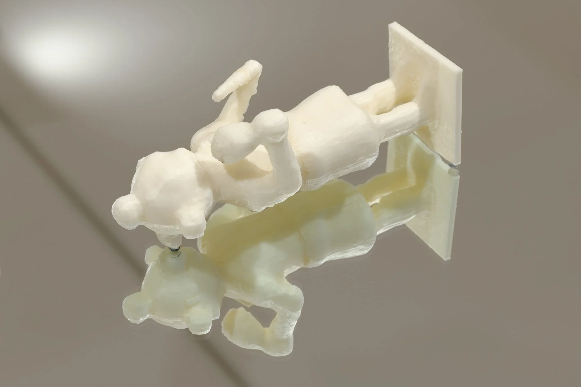 a 3D printed sculpture on a table with a mirror top