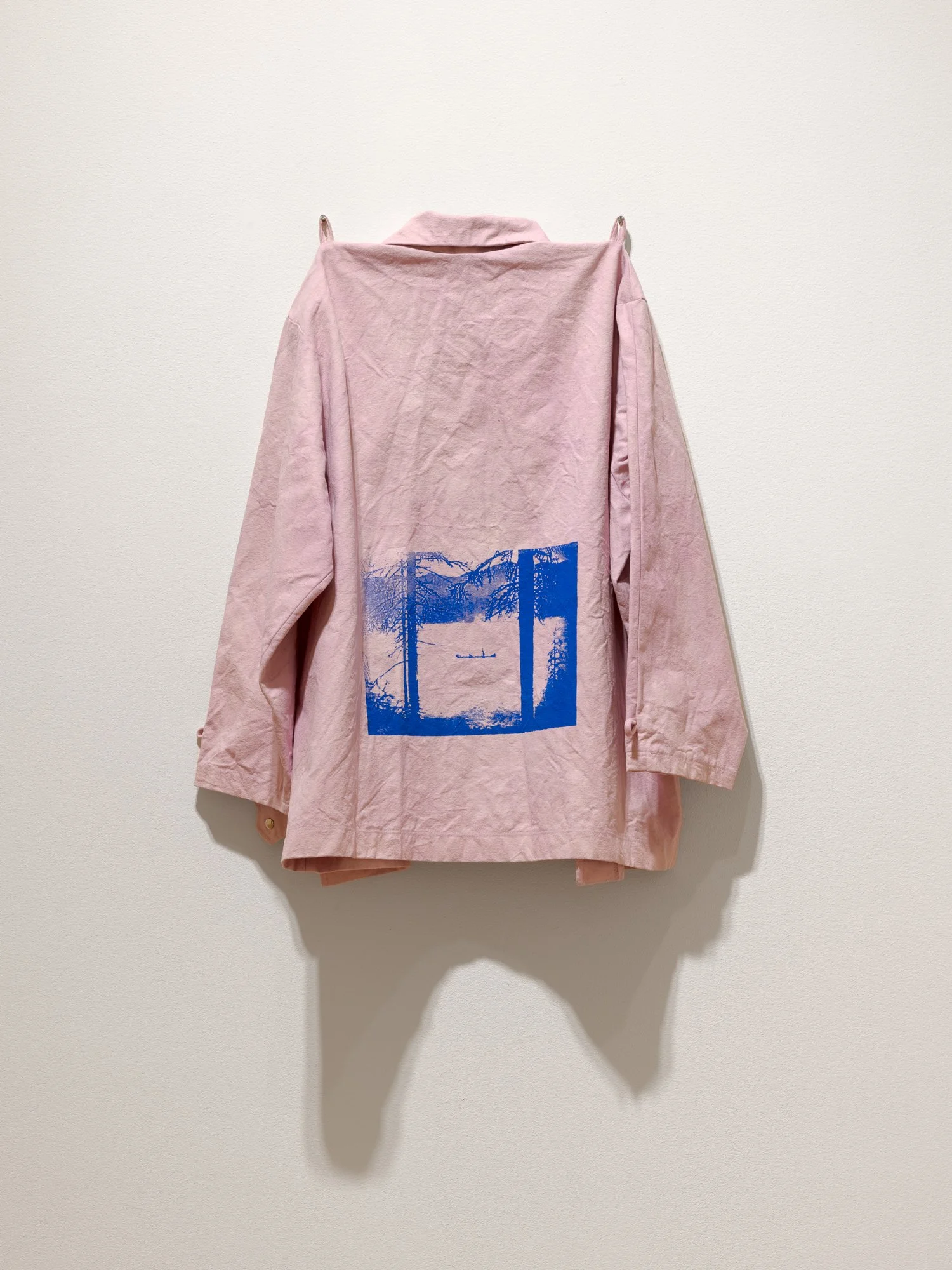 back of a pink jacket showing a blue image