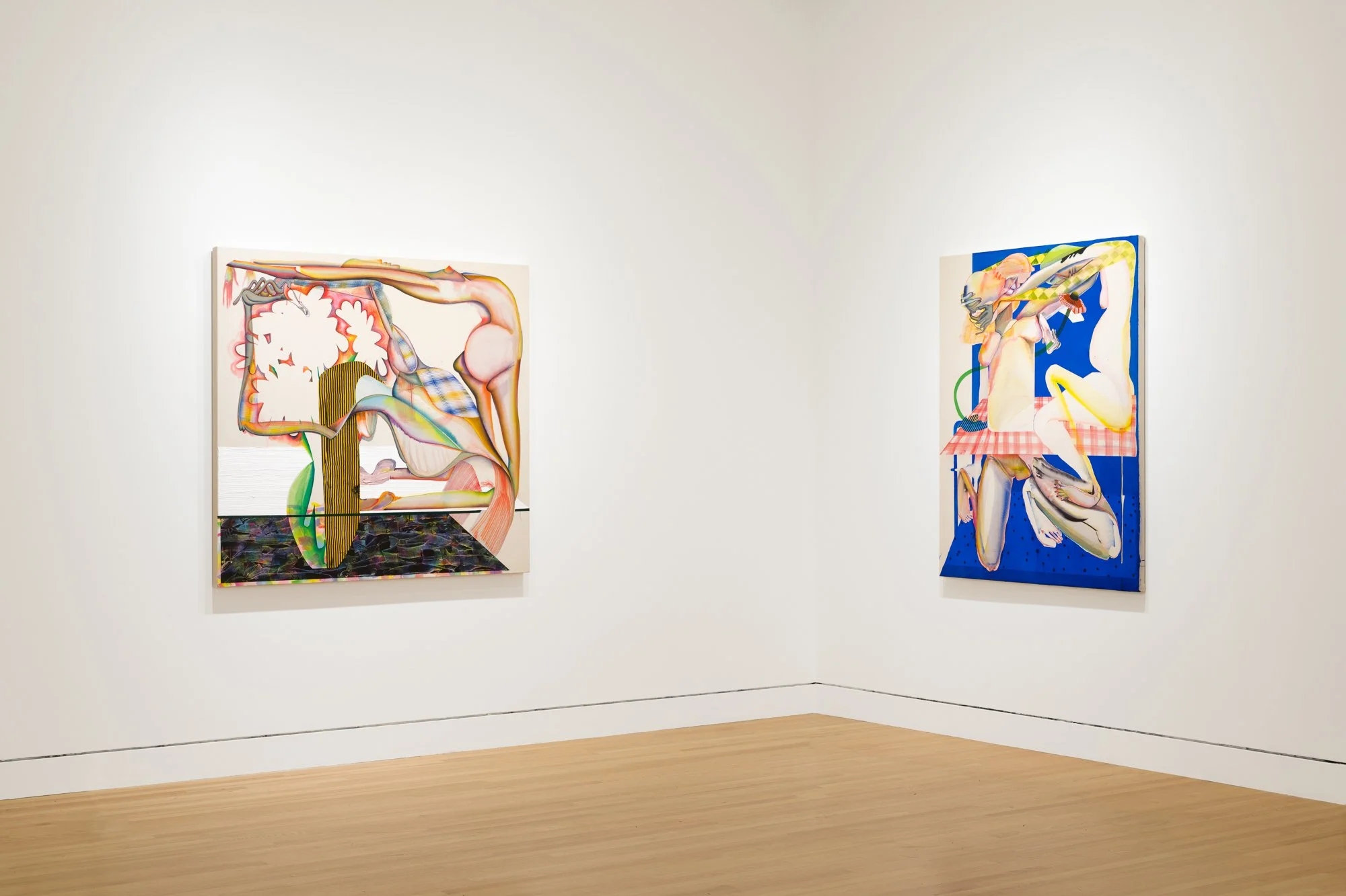 two abstract paintings in a gallery