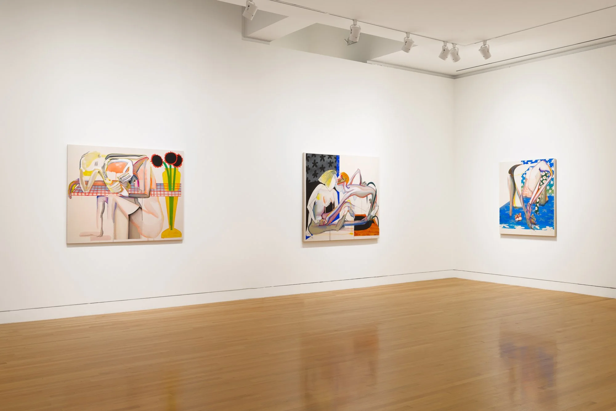 three abstract paintings in a gallery