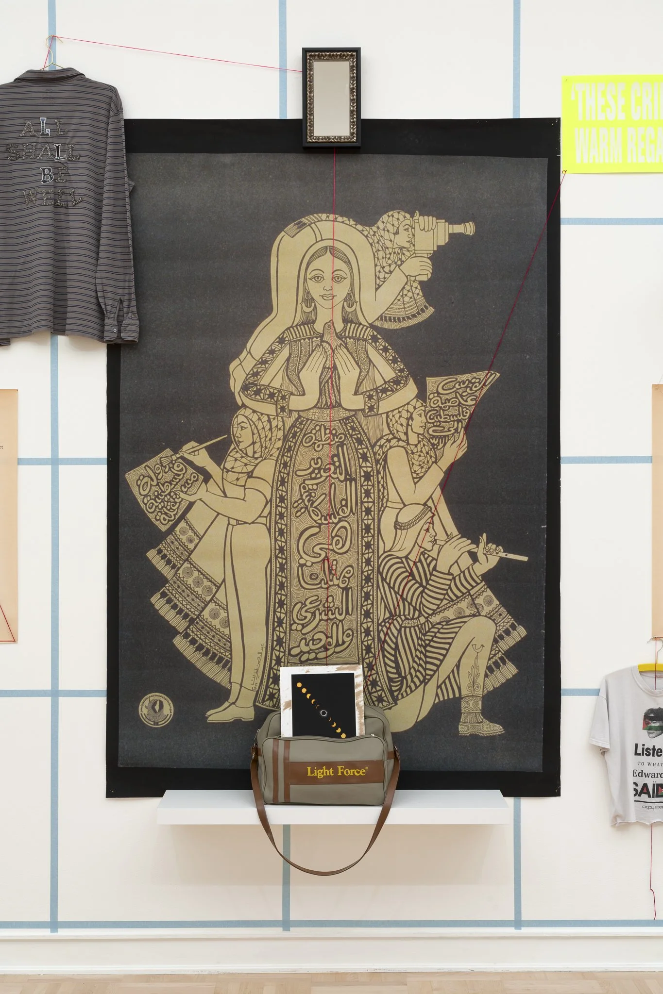 a drawing of three figures in the center; other objects are around the drawing