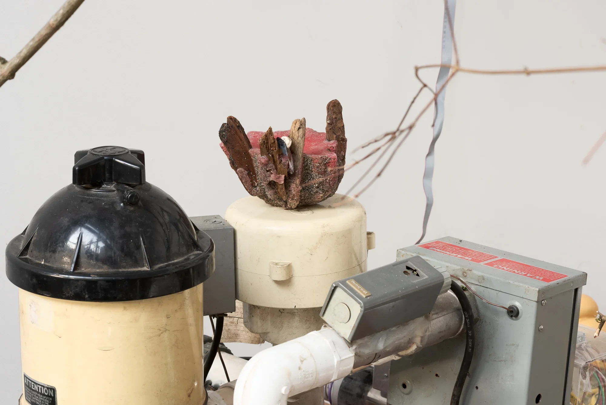 a home-made candle sitting on top of the hot tub pump