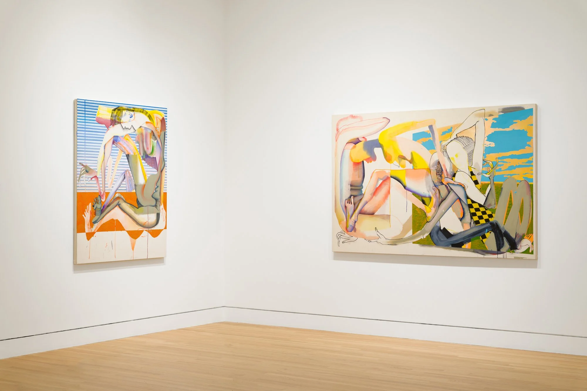 two abstract paintings in a gallery