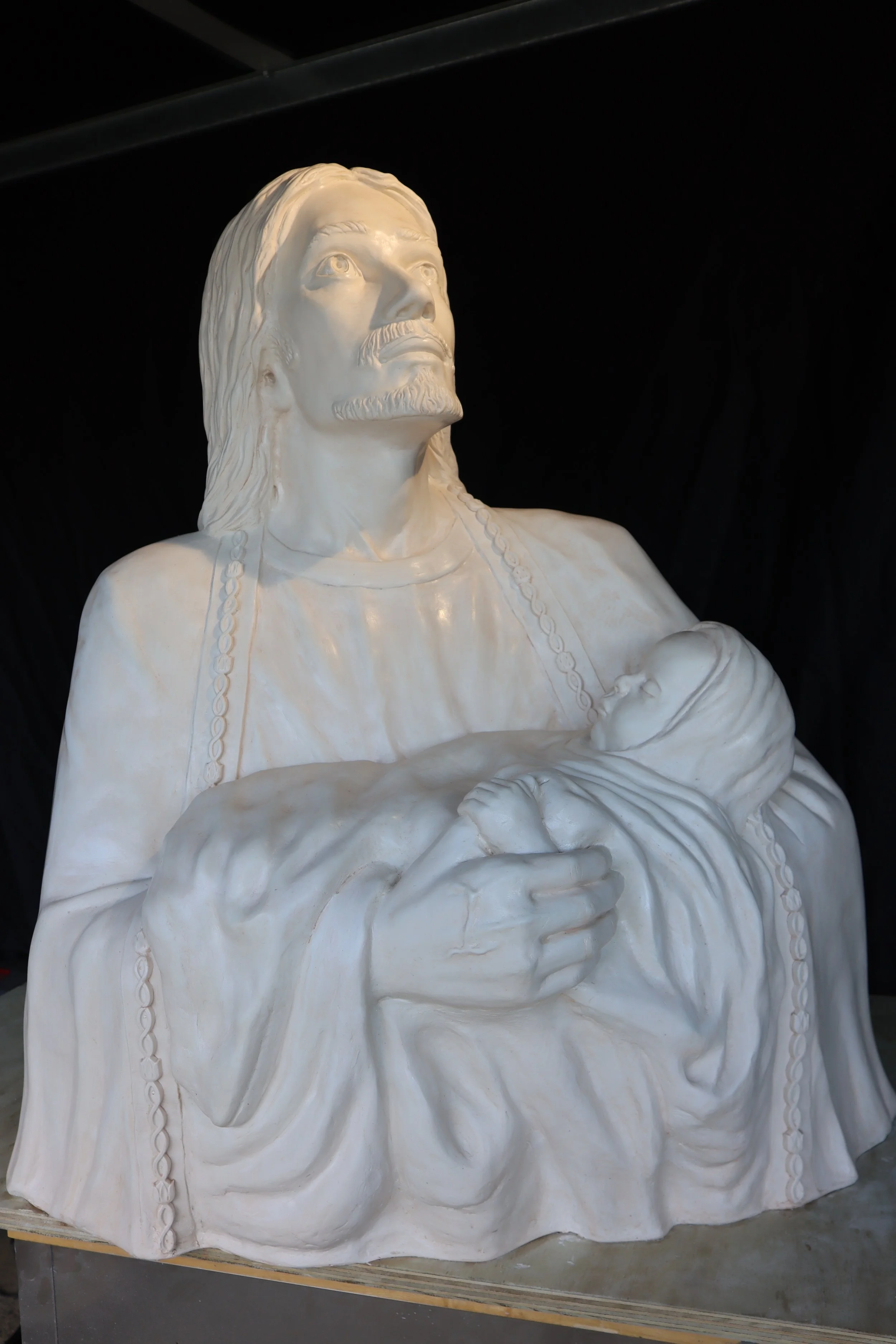 Joseph holding Baby Jesus