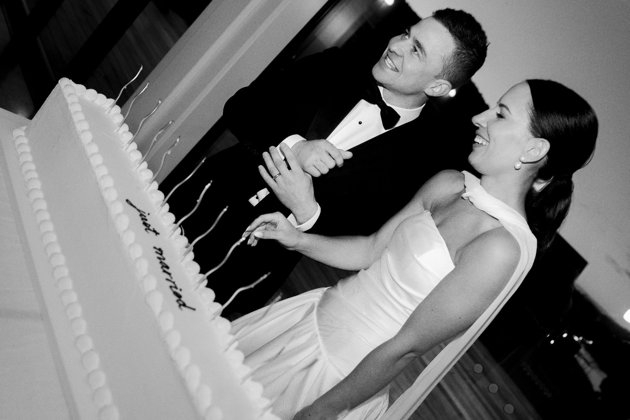 A long white rectangle wedding cake with Just Married piped on top