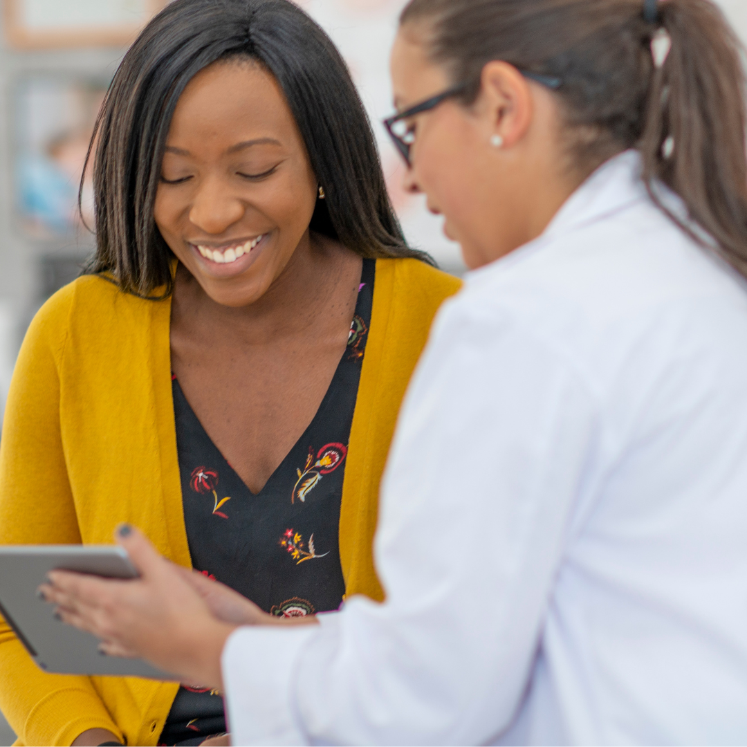 Black pregnant woman talking to healthcare provider