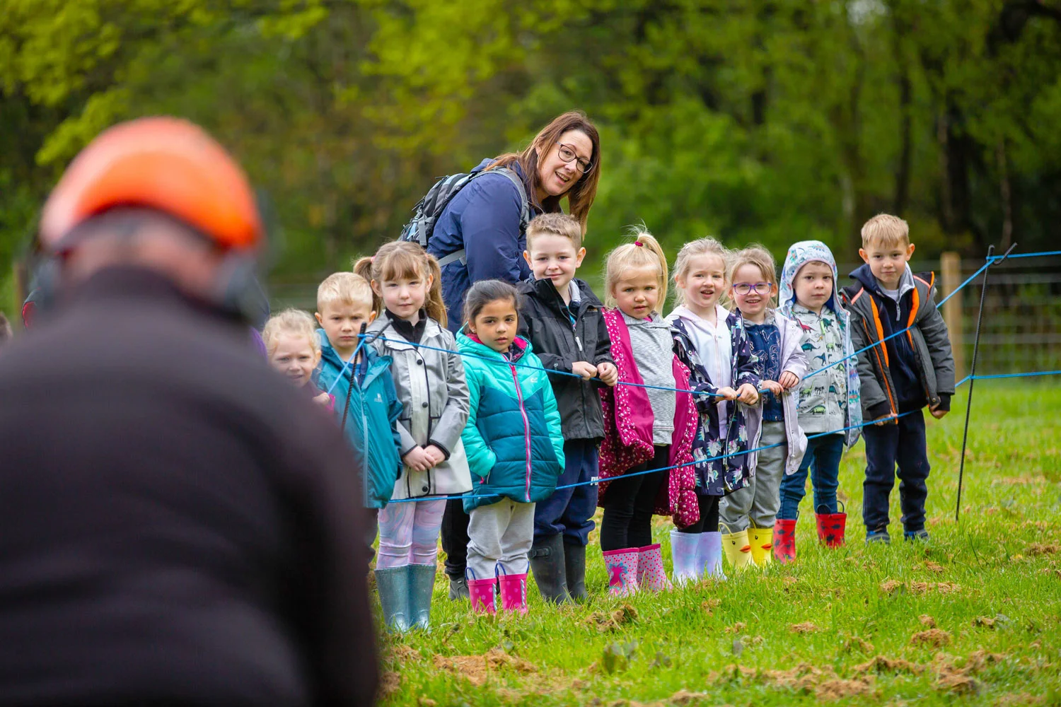 School children watch on during a chain saw demonstration at Great Grounds Education Centre.