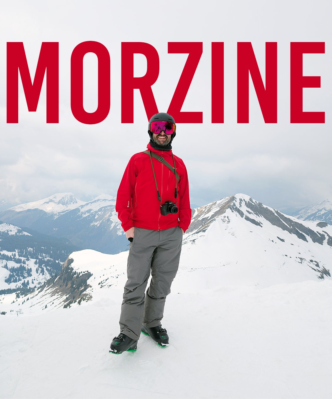 A man standing on snow-covered mountains, wearing a red jacket, gray pants, black helmet, pink goggles, and black boots, with a camera hanging around his neck. The word "MORZINE" in large red letters appears above him.