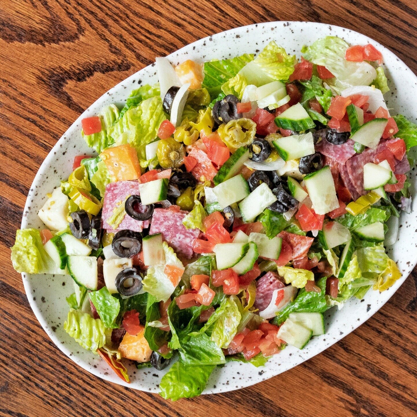 Have you tried our Italian #ChoppedSalad?! Hearty romaine, salami, pepperoni, tomato, onion, pepperoncini, cucumber, green pepper, cheddar, swiss, olives, all tossed in italian grinder style dressing &amp; chopped to PERFECTION!