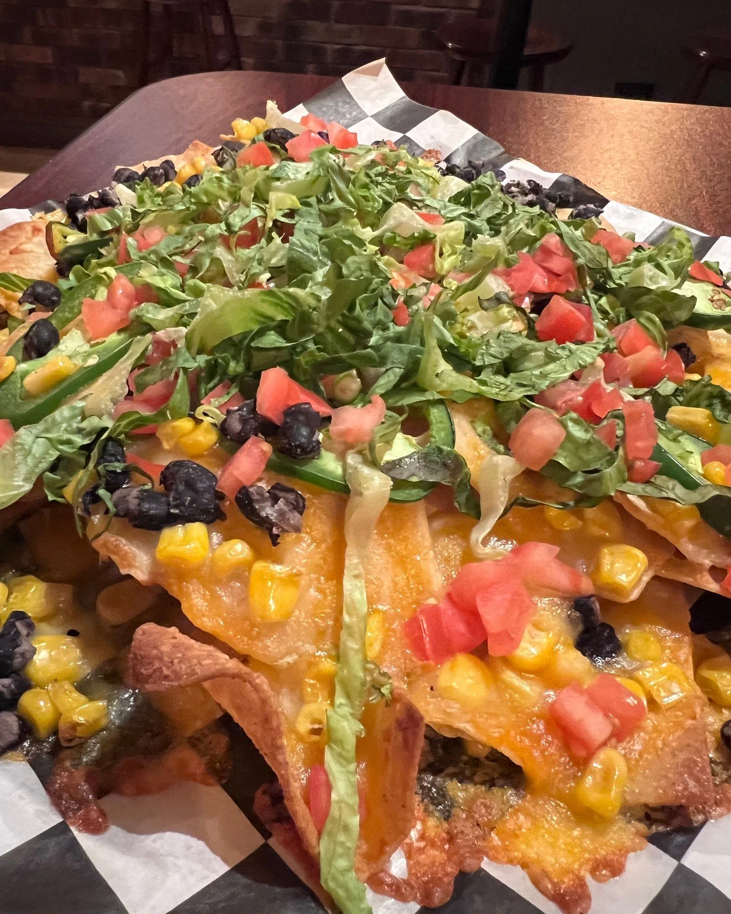 Nachos that pull their weight💪
Crispy tortilla chips piled high with cheddar jack, lettuce, tomato, black beans, corn &amp; jalape&ntilde;os. Chicken or guac? Your call, but go big or go home! 🧀🌶️🥑