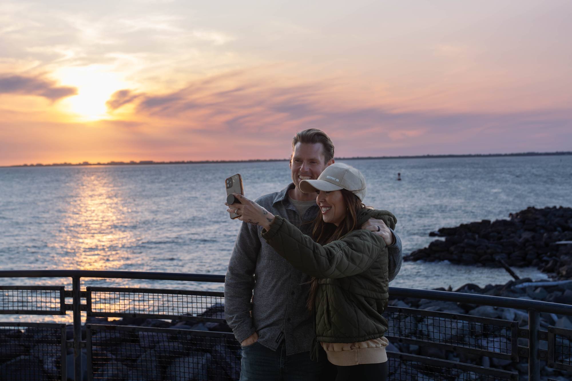 Couple taking selfie at sunset from observation deck