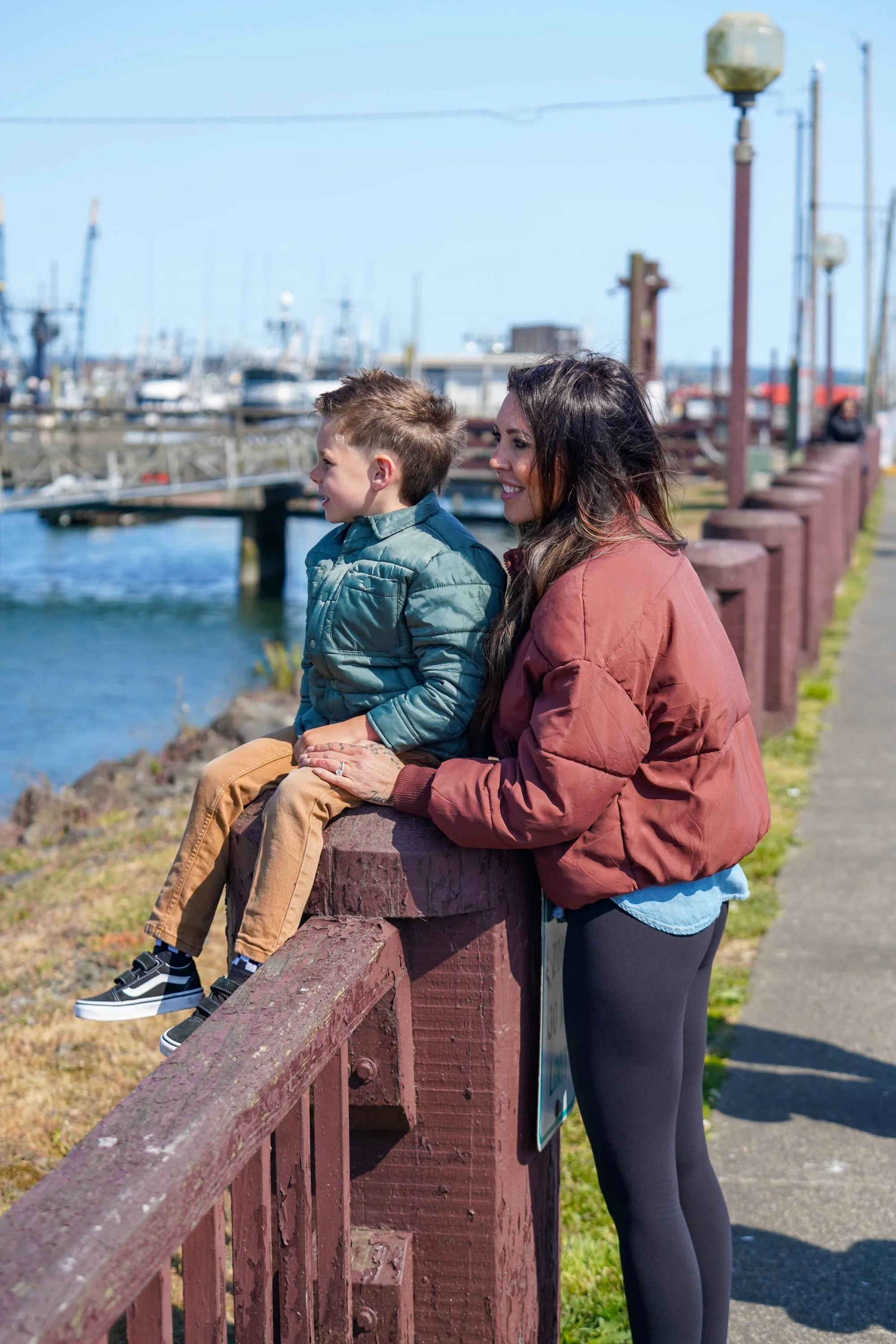 Mother and son looking a harbor docks and boats