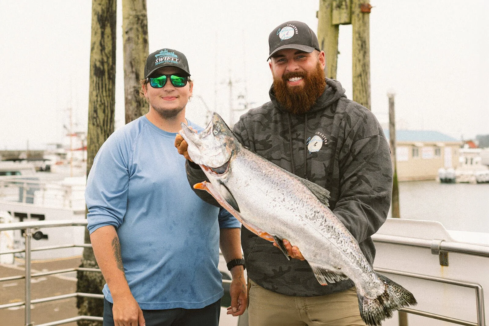 Happy fishermen showing caught chinook