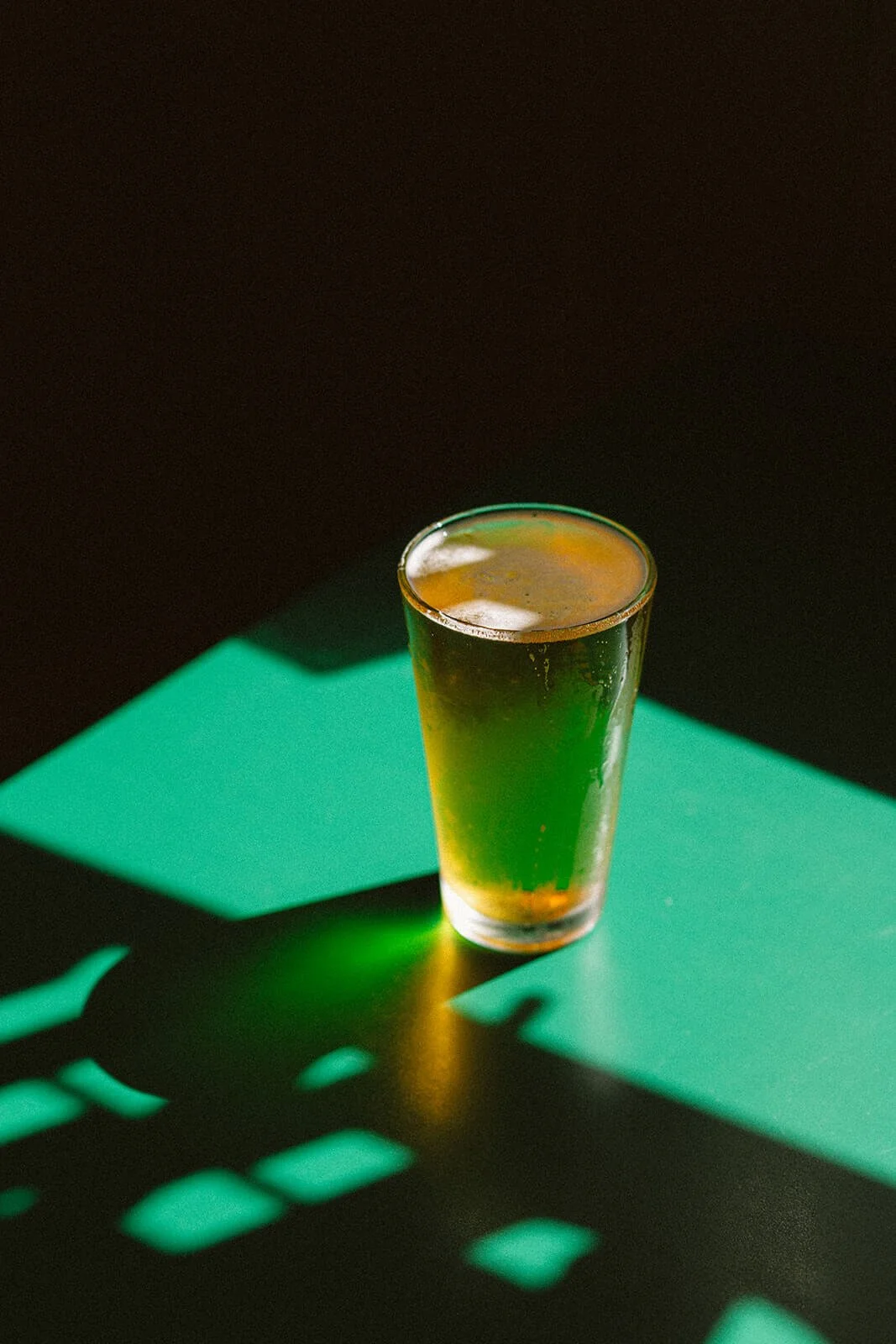 Pint of beer casting shadow
