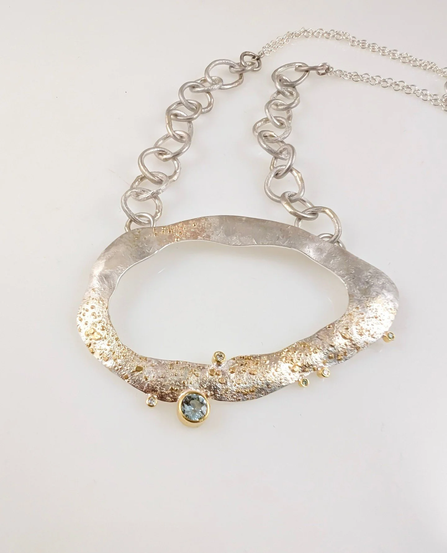 "Full Moon Glow Moondust ⁠
Reef Necklace" with glitz and glam,⁠
soft tones, and yet, warmth.⁠ 🌕️⁠
⁠
Happy full moon and partial lunar eclipse! This beauty sold very quickly after leaving the bench. She dons a pale blue North Missouri River