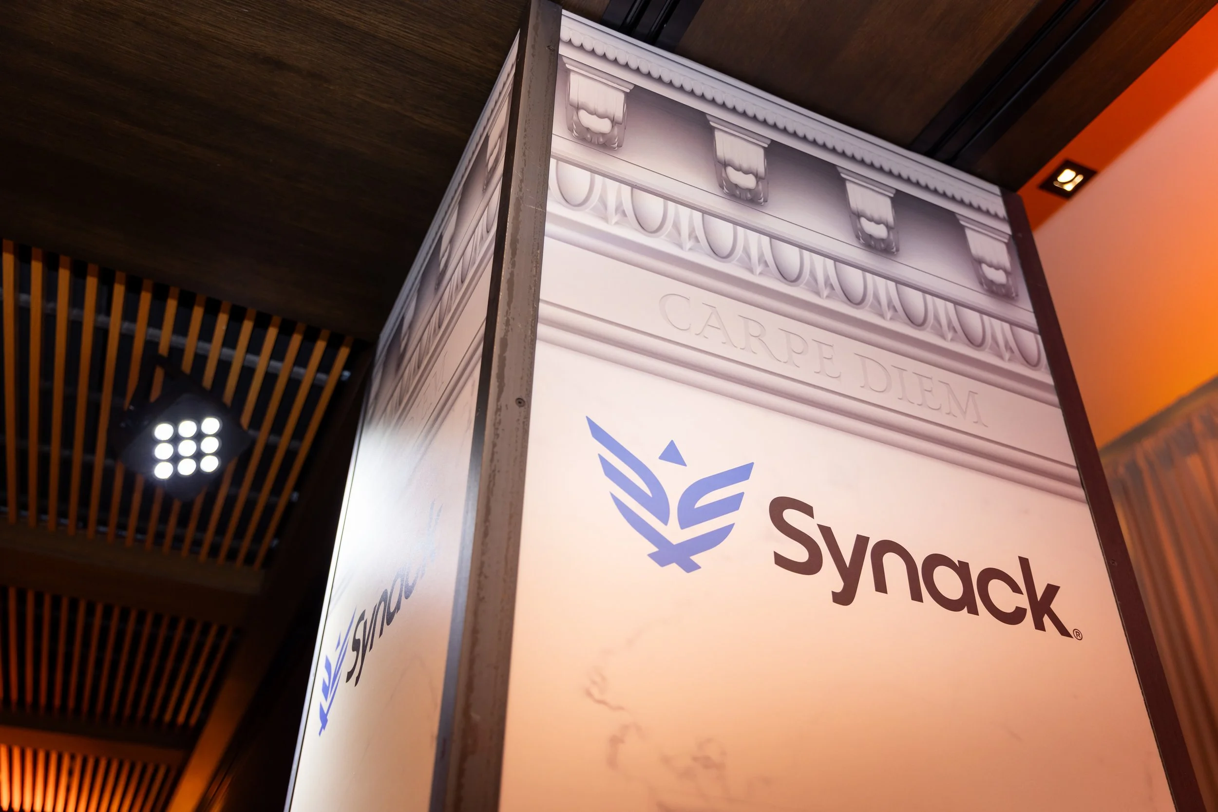 Ancient Roman cornice, carved out effect of Carpe Diem and Synack logo on the columns.