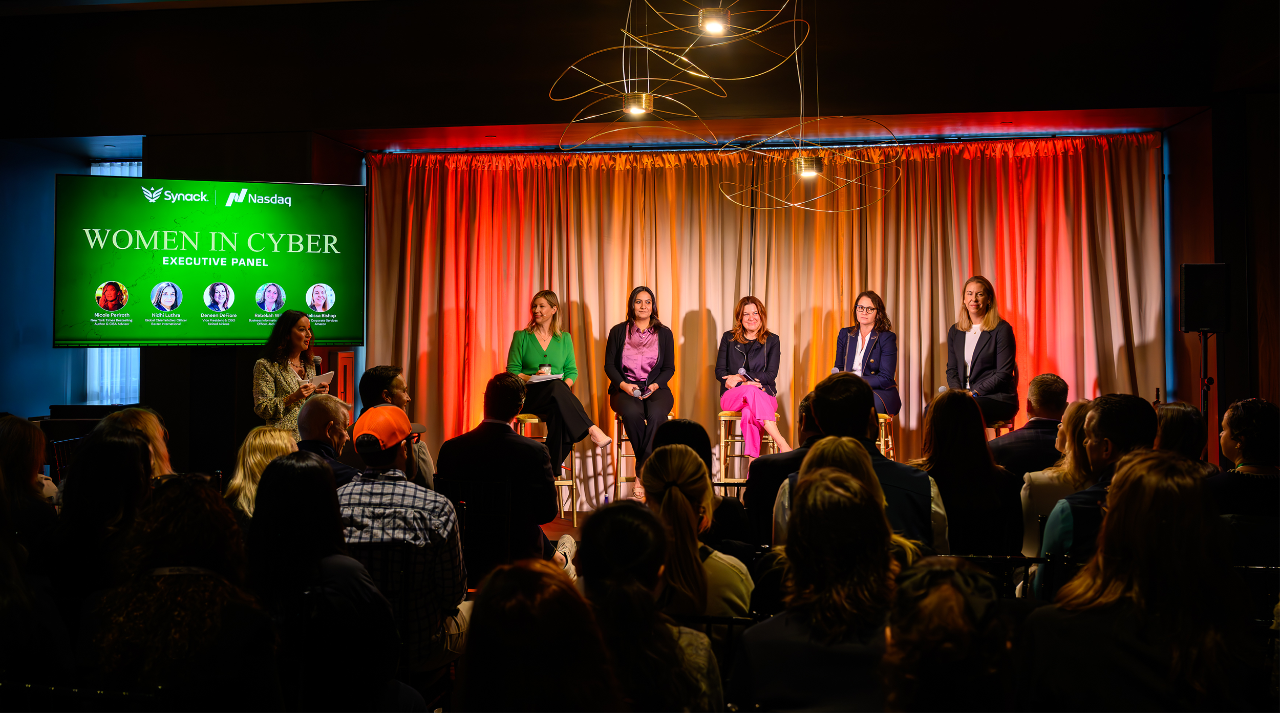 The “Women in Cyber” executive panel featured five influential women sharing insights on how female security leaders are evolving strategies to address today’s challenges. The backdrop with the dramatic red and orange uplighted drapes created a po
