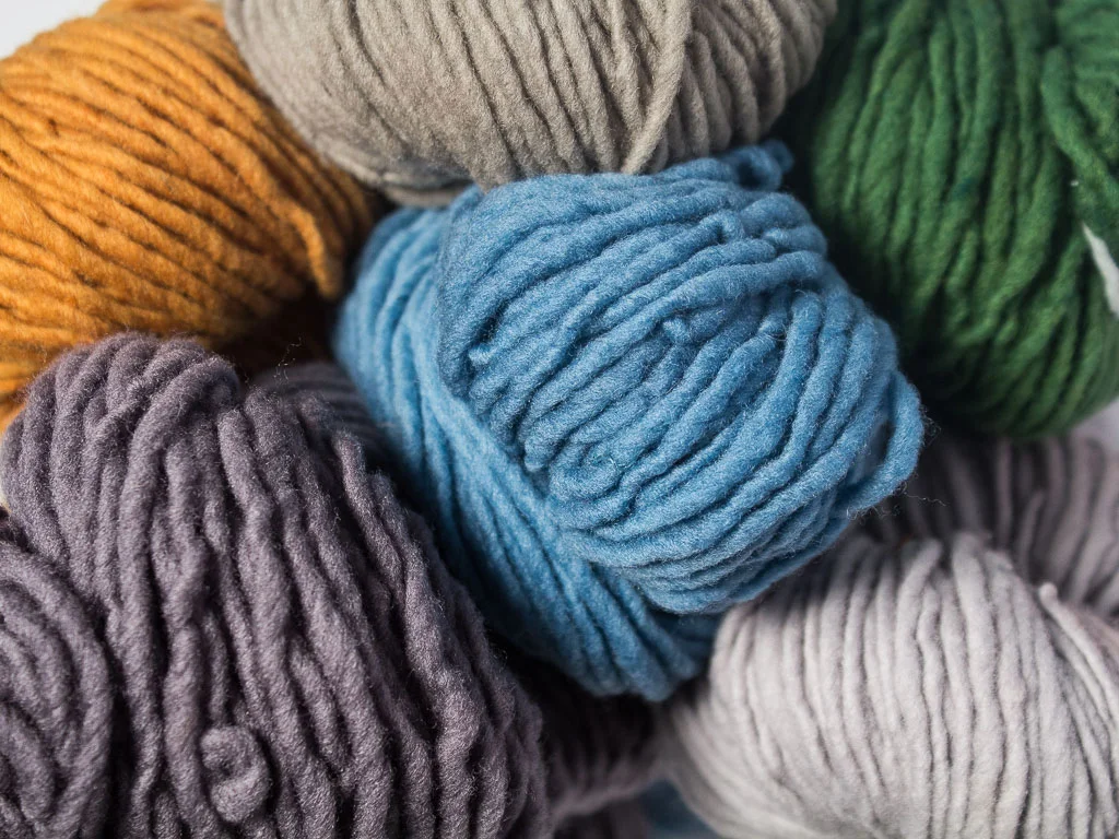 group of merino wool skeins in worsted weight