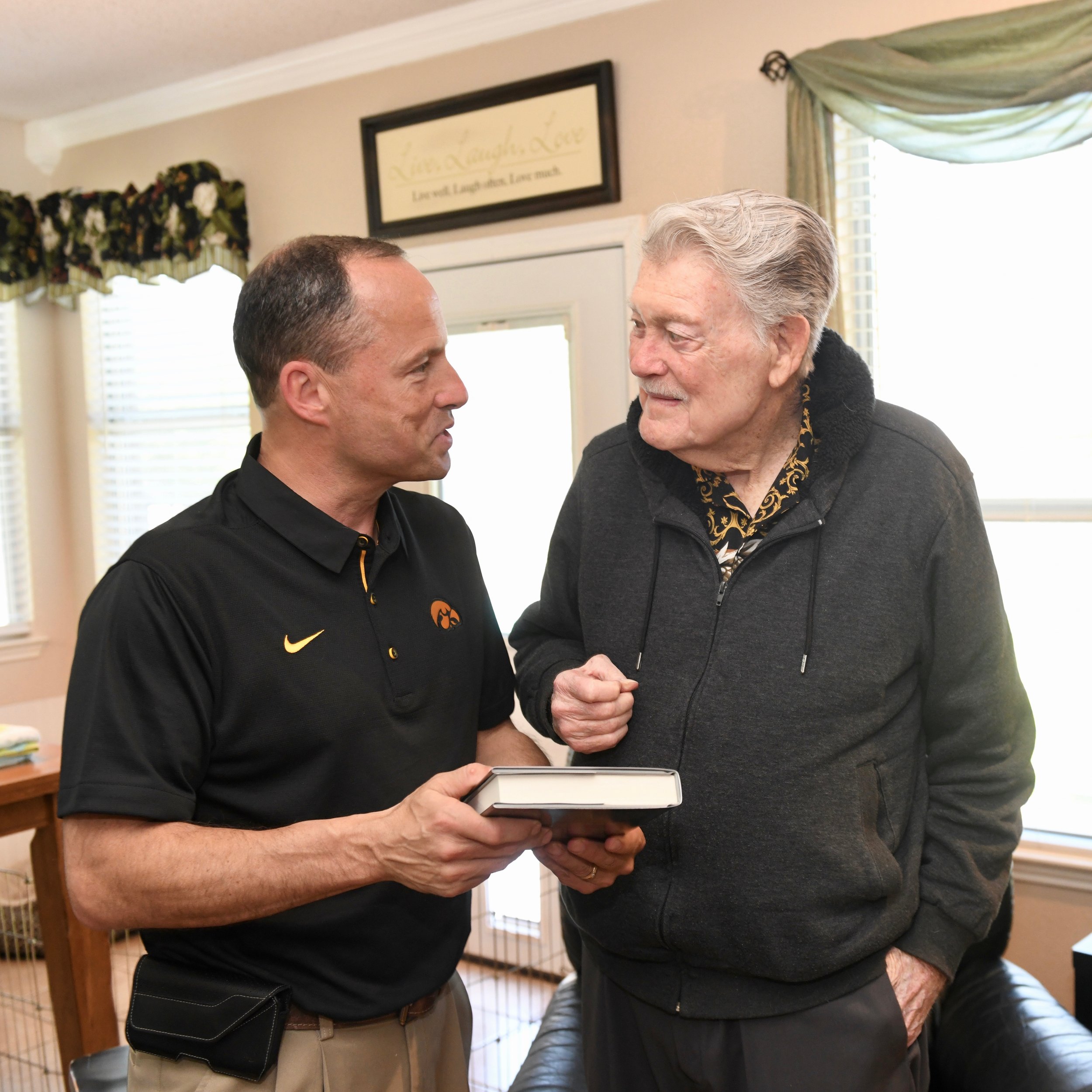 Aaron presenting book to Hayden Fry 4-26-18.jpg