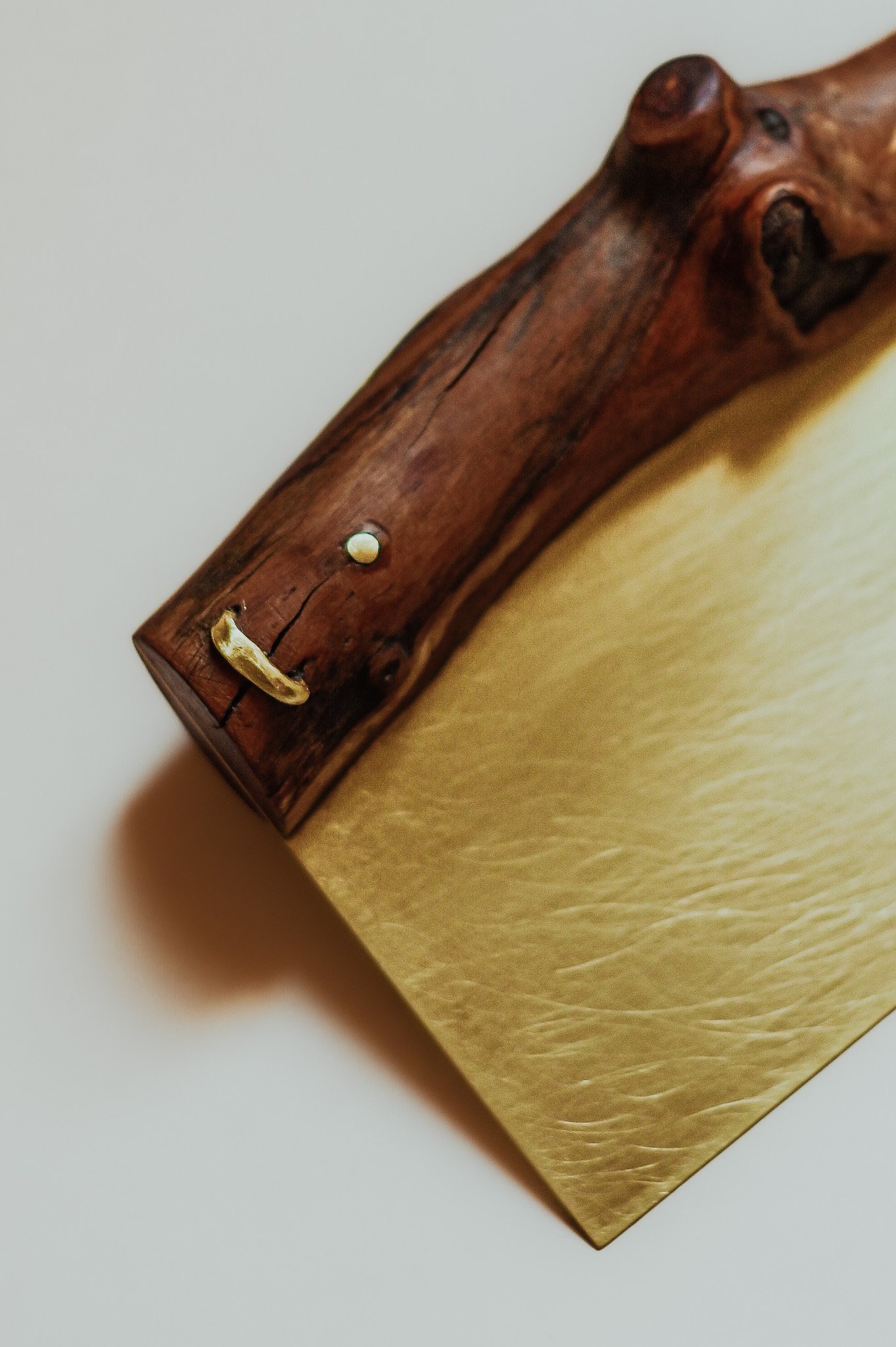 Close-up of a brass mend on an Apple Branch Bench Scraper.