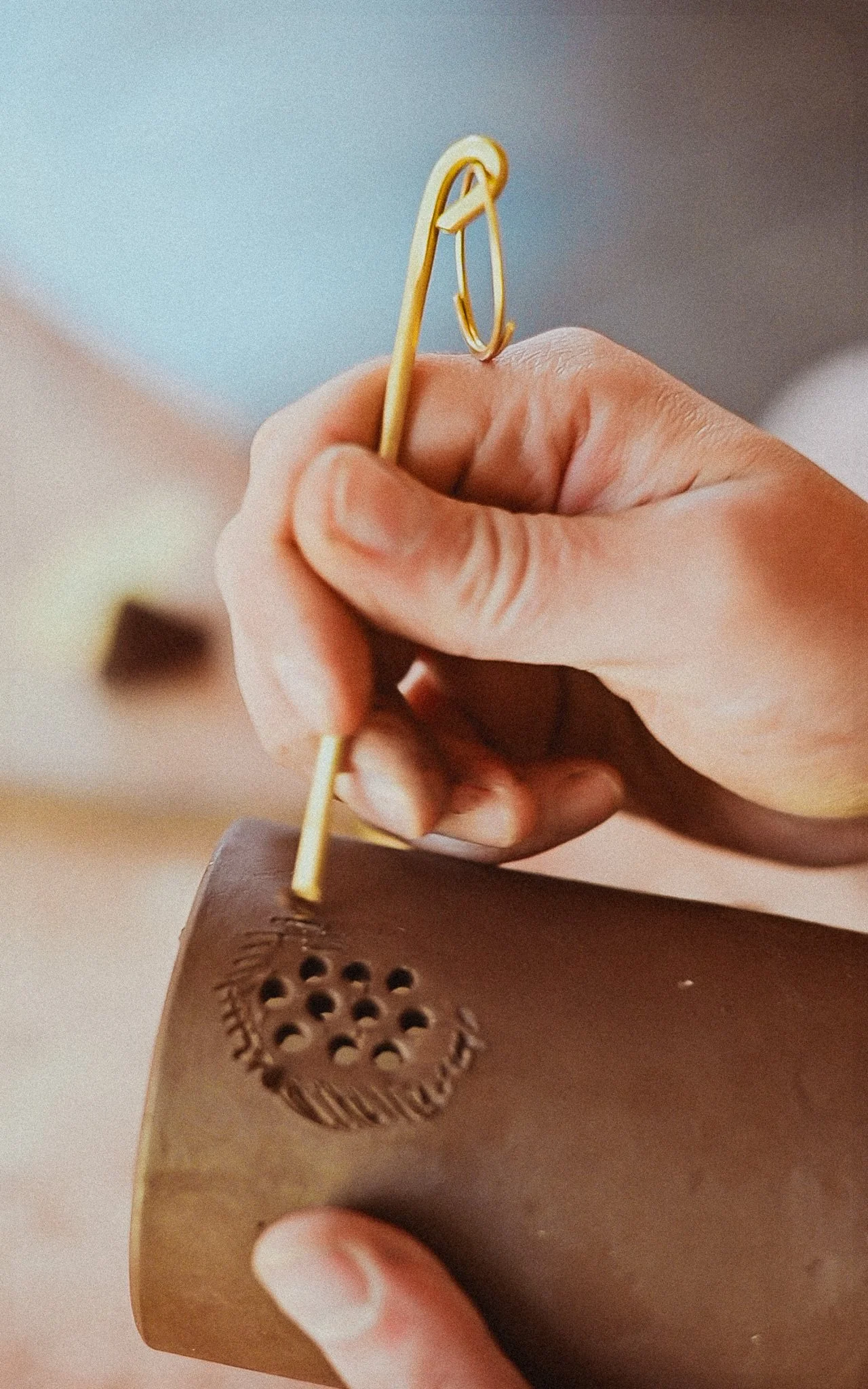 Using the plunger to etch and score the clay.