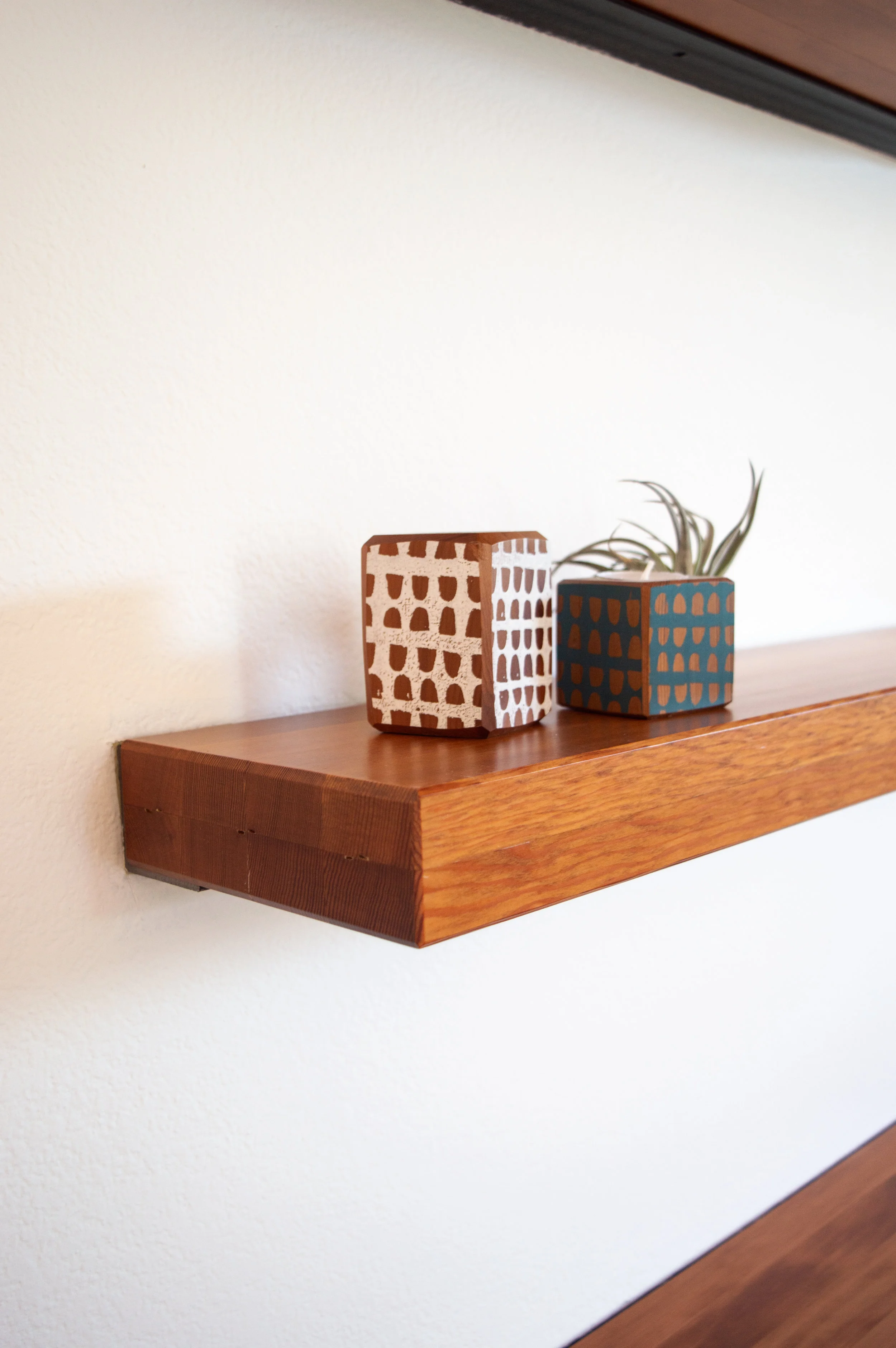 Example of the floating shelves hanging. Note that the workshop will be using Spalted Maple wood which is different than what is in the photo above.