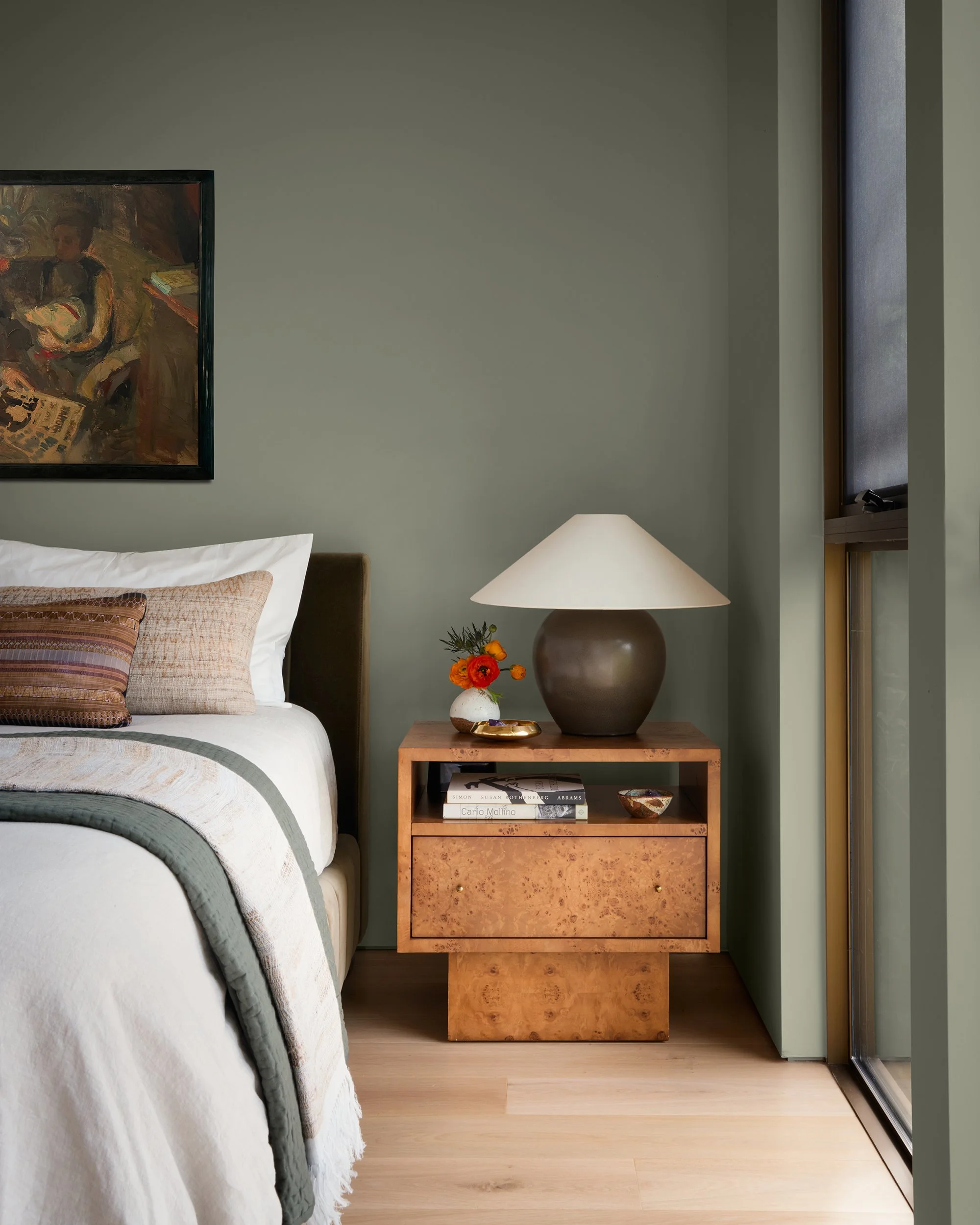 Moody green textural bedroom vignette flowers lamp