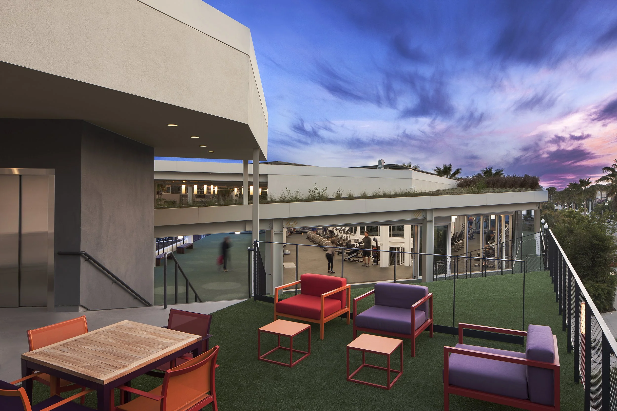 The-Resort-Community-Center-Roof-Deck-Gym-Colorful-Furniture-Sunset.jpg