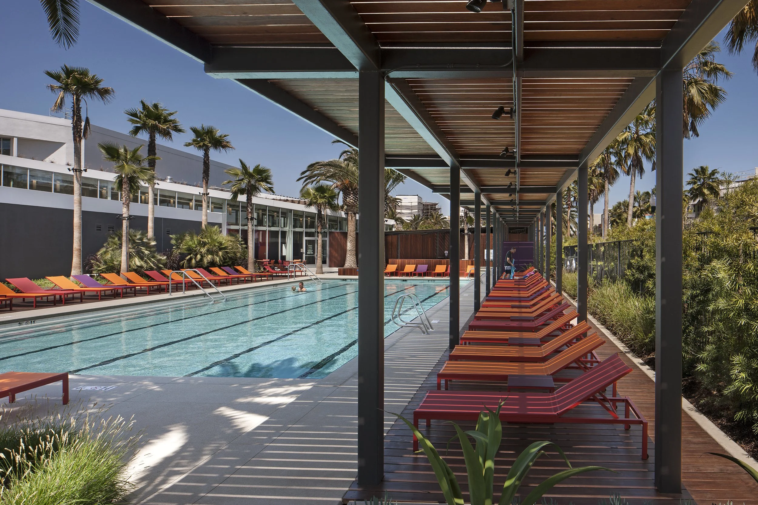 The-Resort-Community-Center-Pool-Shade-Structure-Colorful-Chaise-Lounges.jpg