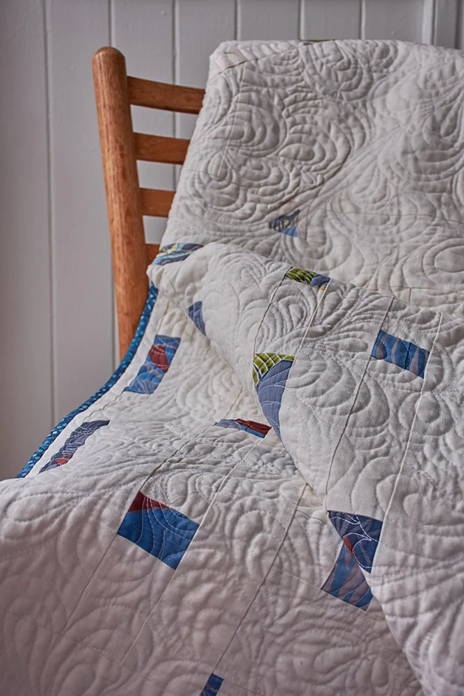 Silk, cotton, and linen quilt with coconut buttons
