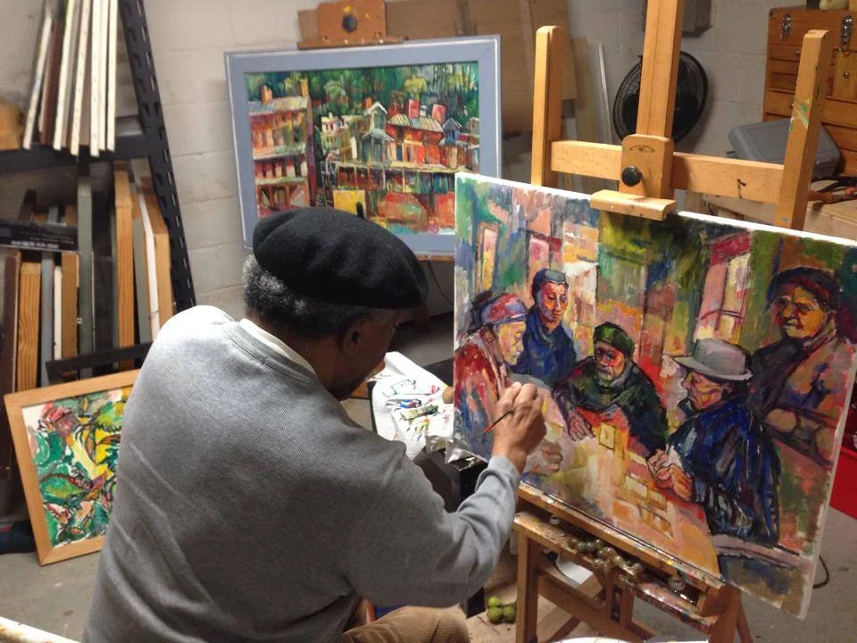 Edward working on an older collection piece of card players in his home studio.