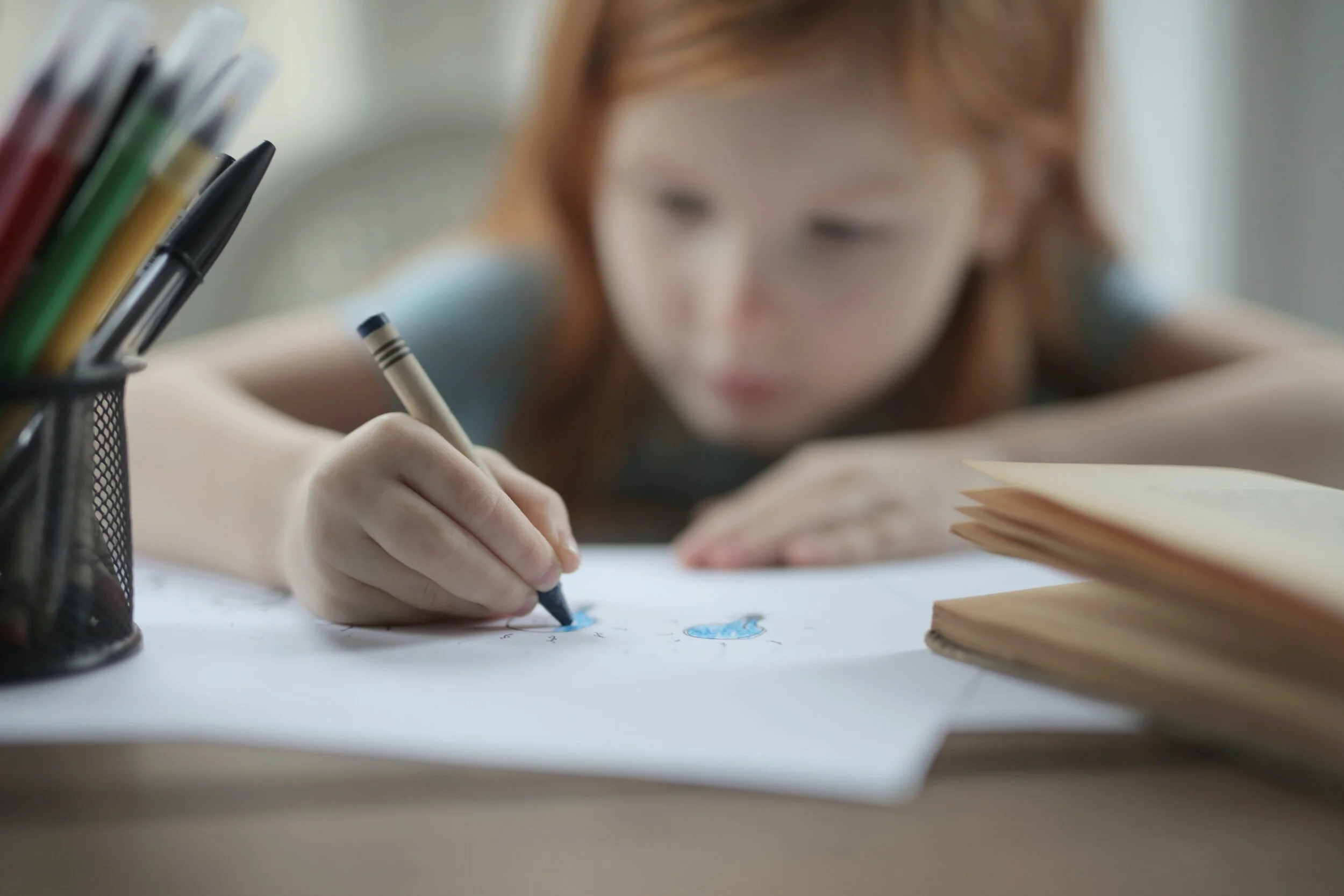 girl-holding-crayon-coloring-white-paper-3891193.jpg