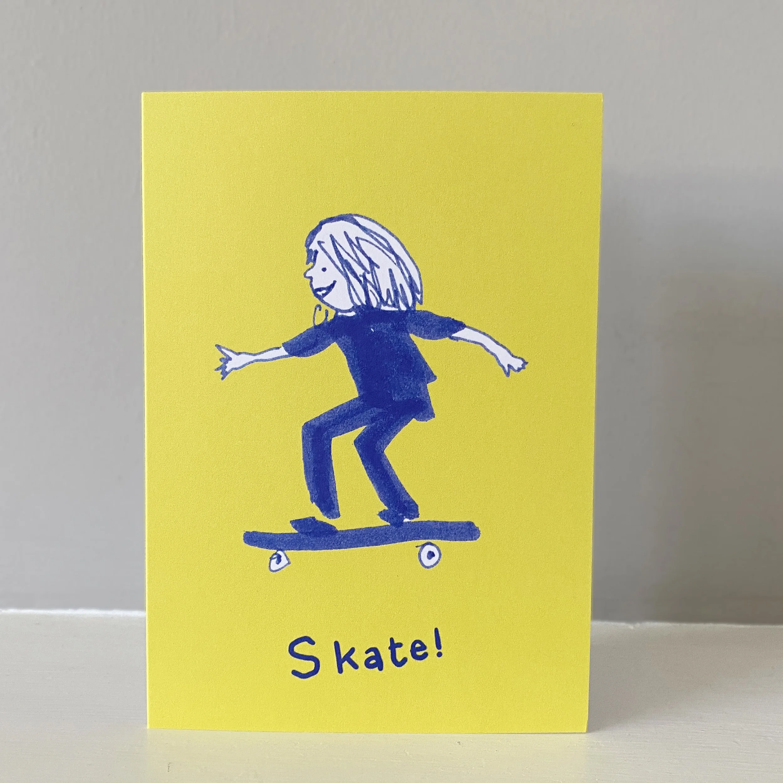 Child on skateboard greetings card