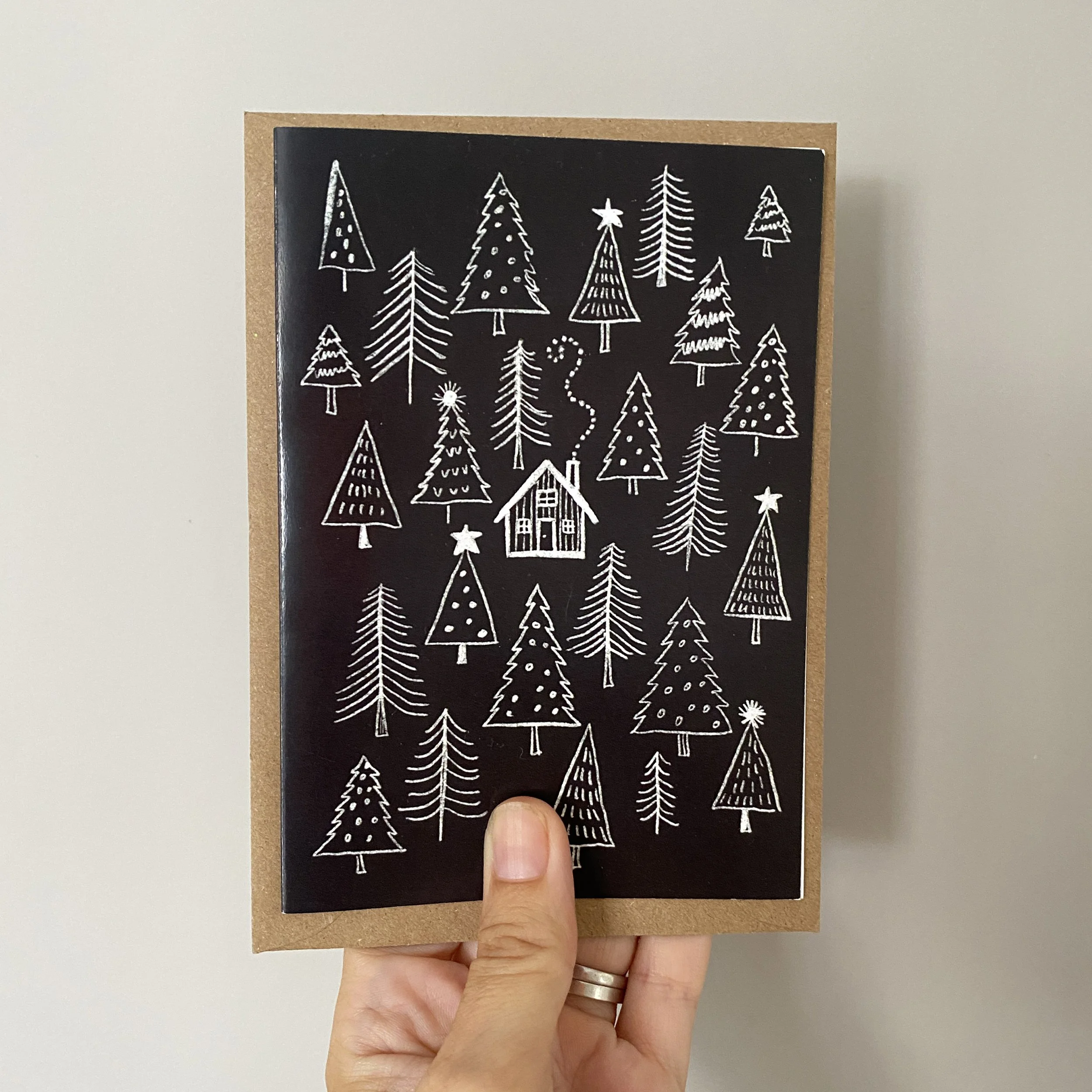 log cabin in pine forest christmas card