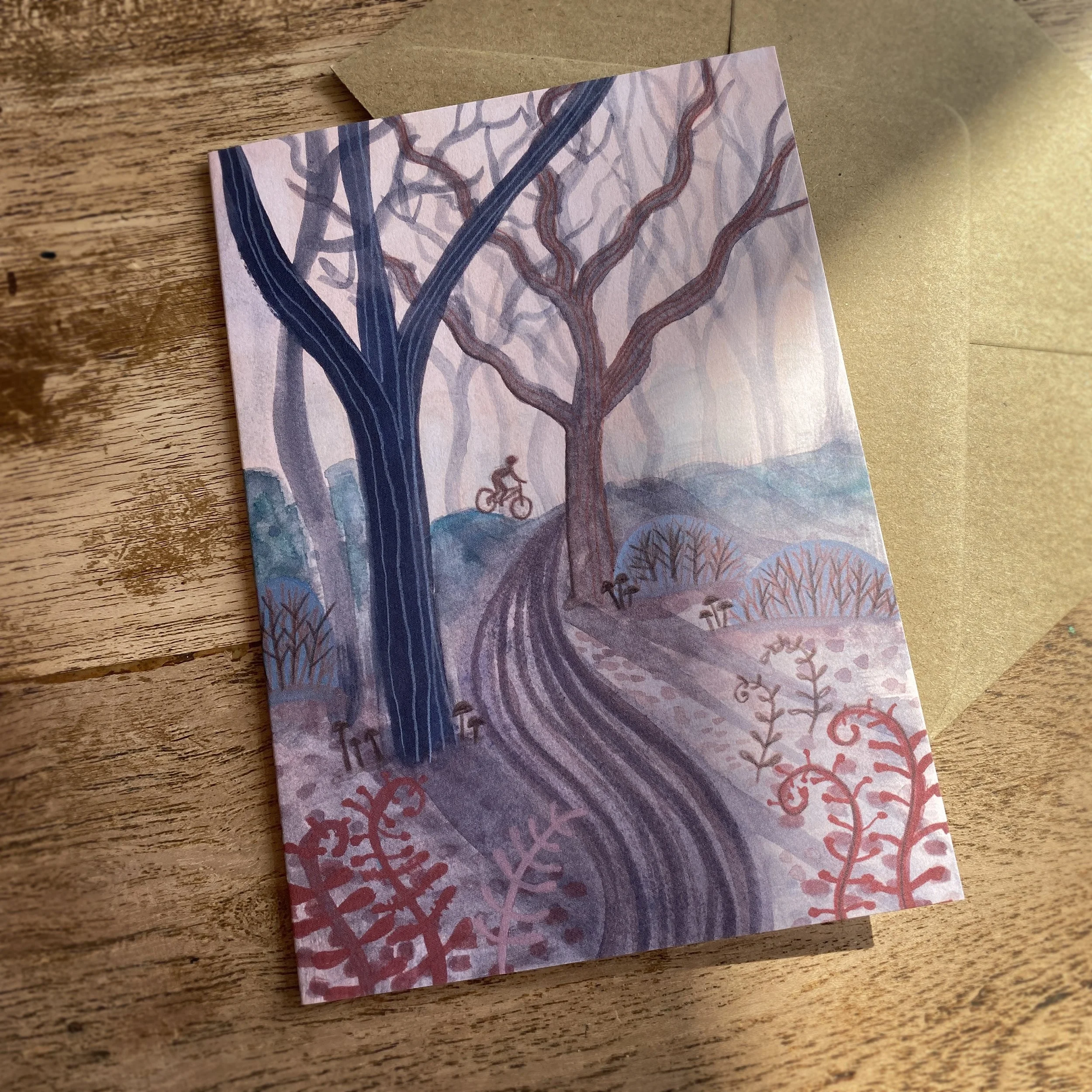 cyclist in forest greetings card