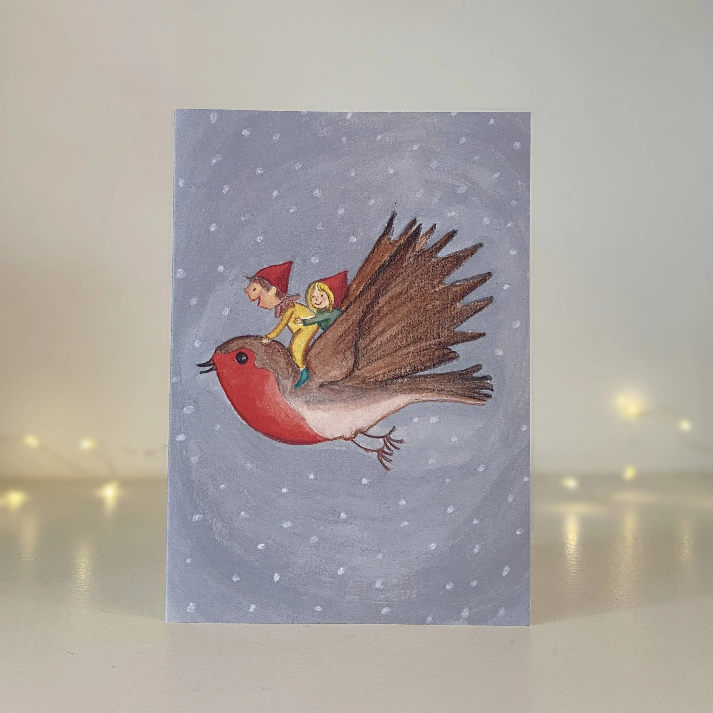 elves flying on a robin christmas card