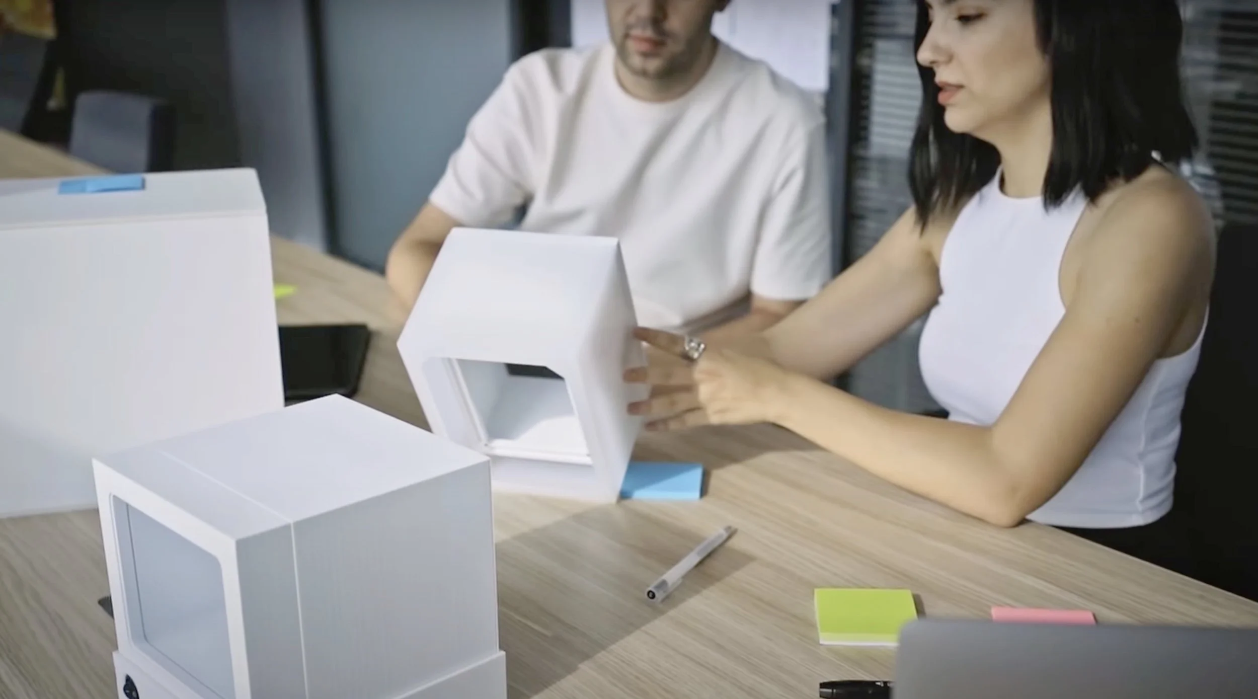 Examining a design's 3D printed mockup with other similar mockups and taking notes