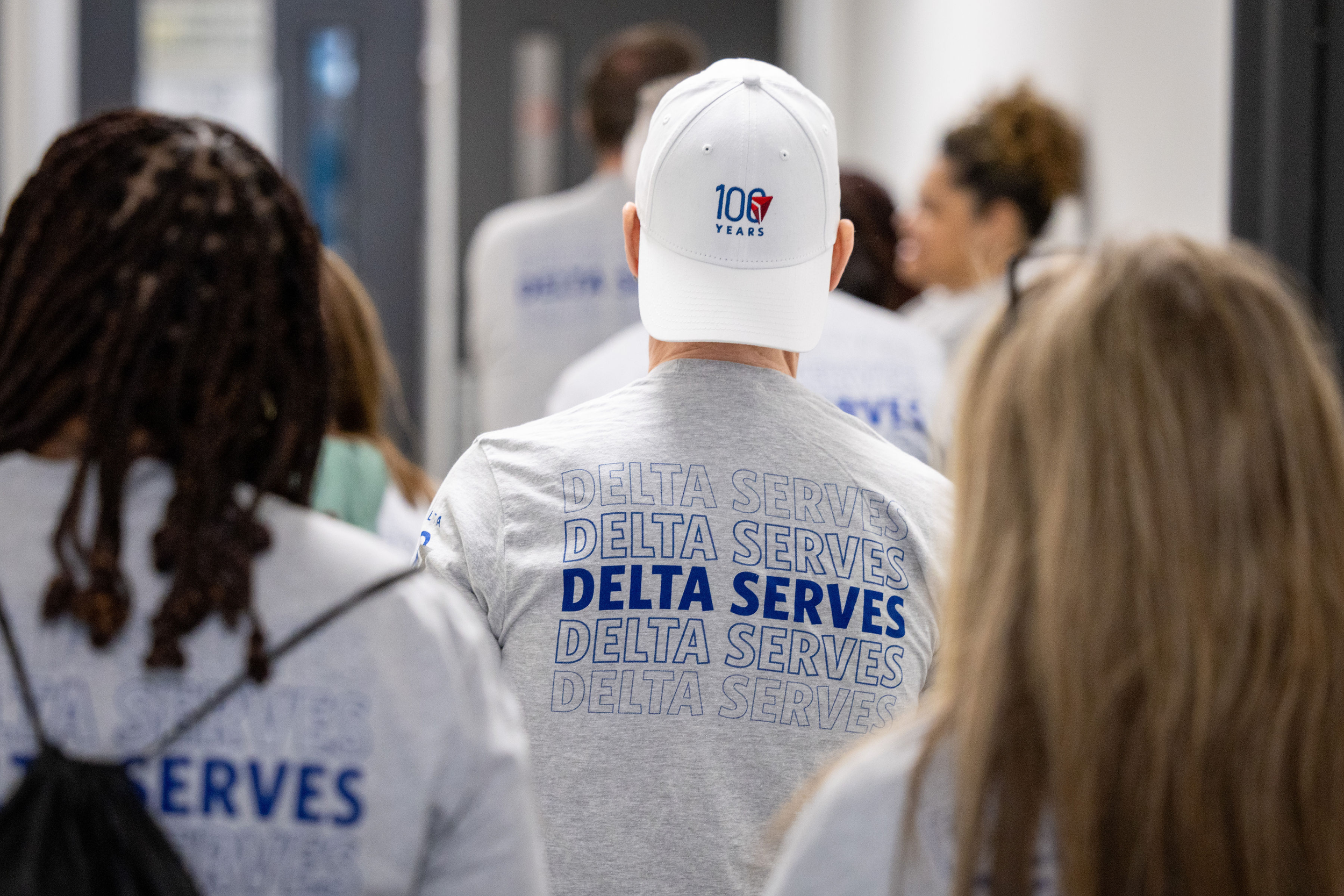 May be an image of _3 people and _text that says '_10G YEARS DELTA SERVE DELTA SERVES DELTA SERVES DELTA SERVES DELTA ة ERVES_'__.png