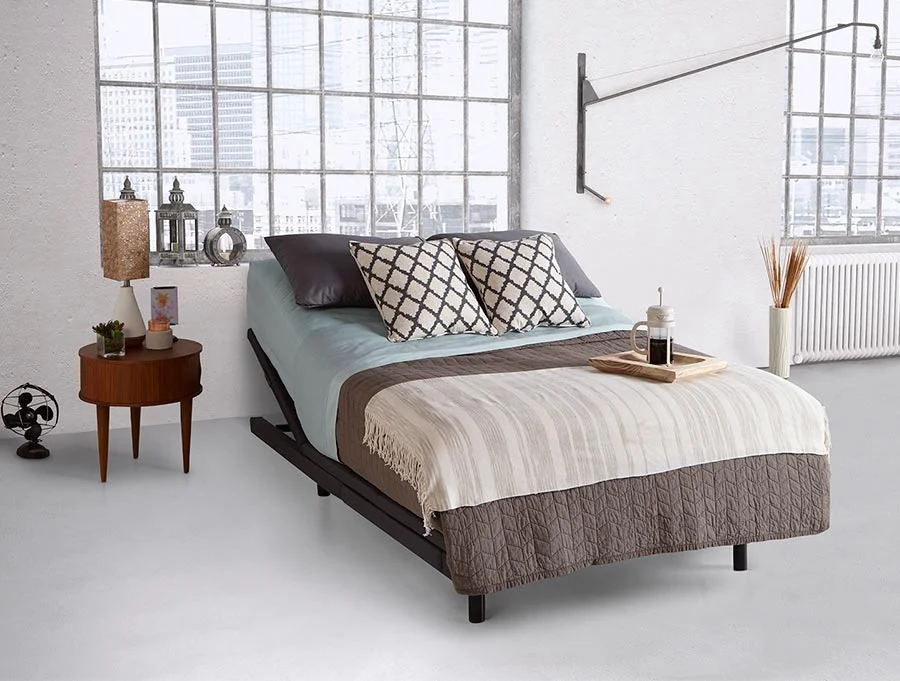 Picture of Rize Verge adjustable base in bedroom with bedspread on top.