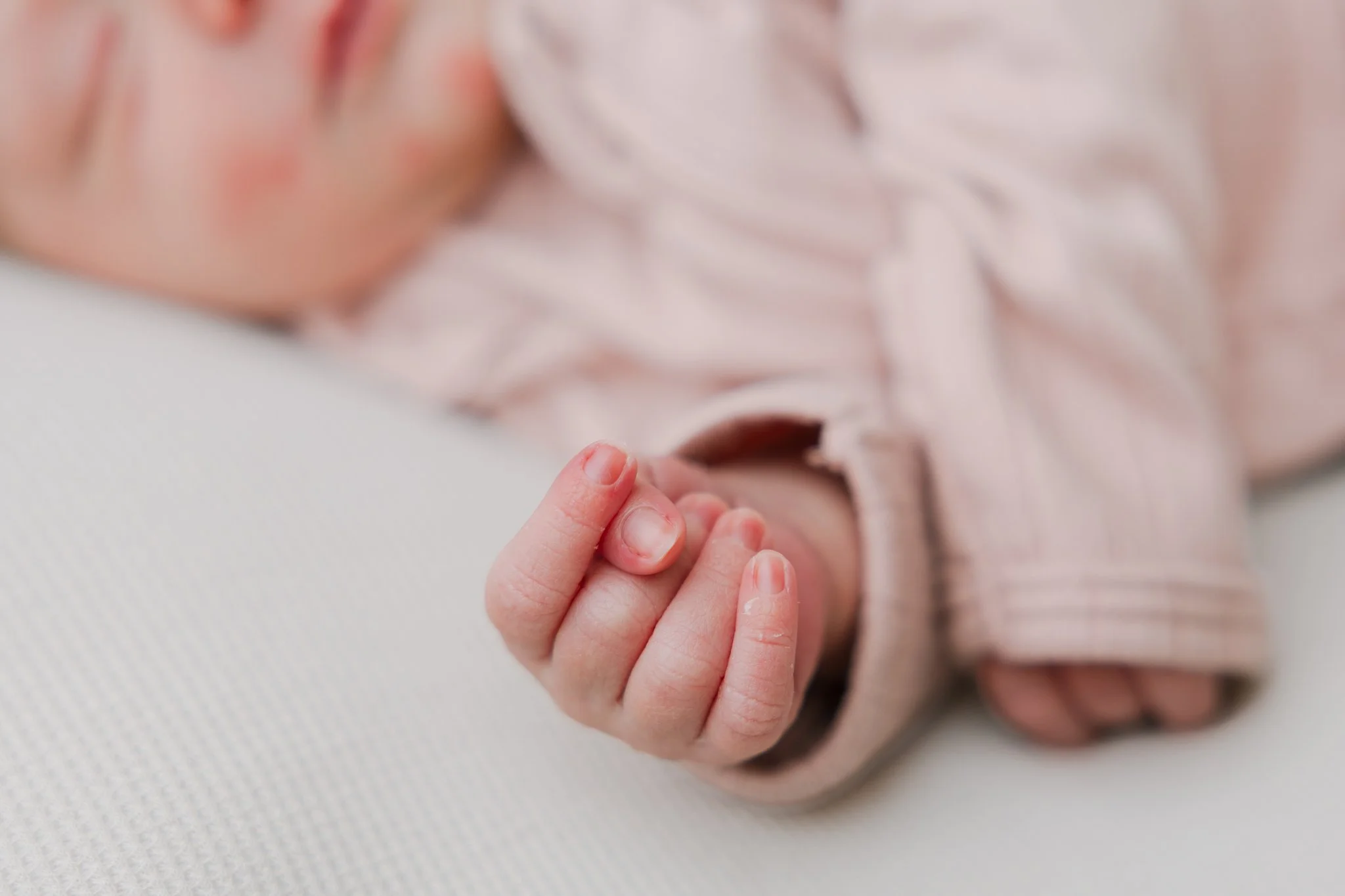 Sleeping newborn baby and her little hand details during a Tampa, FL at home newborn session.