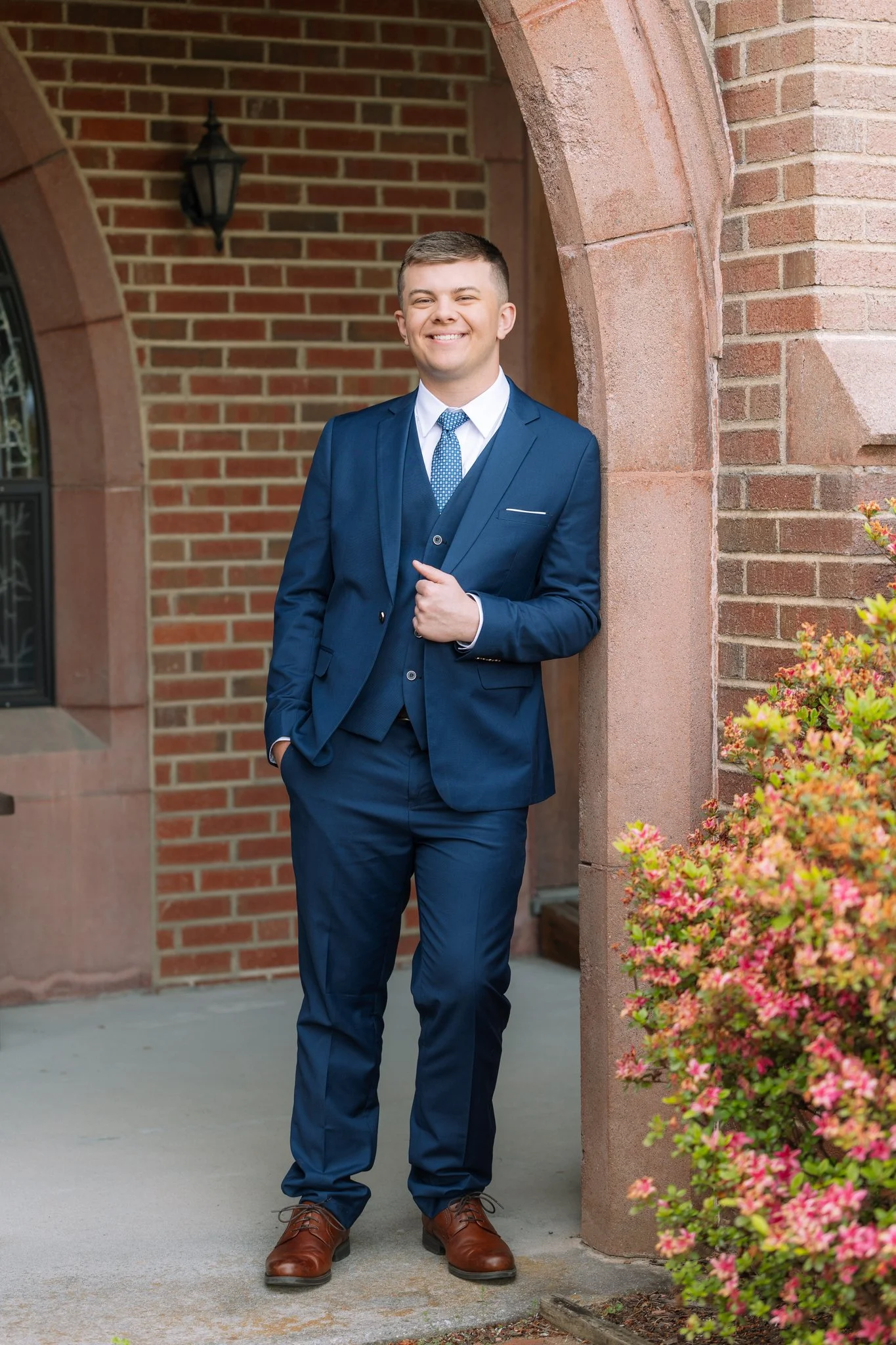 A male graduate posing for a senior photo session in Tampa, FL.