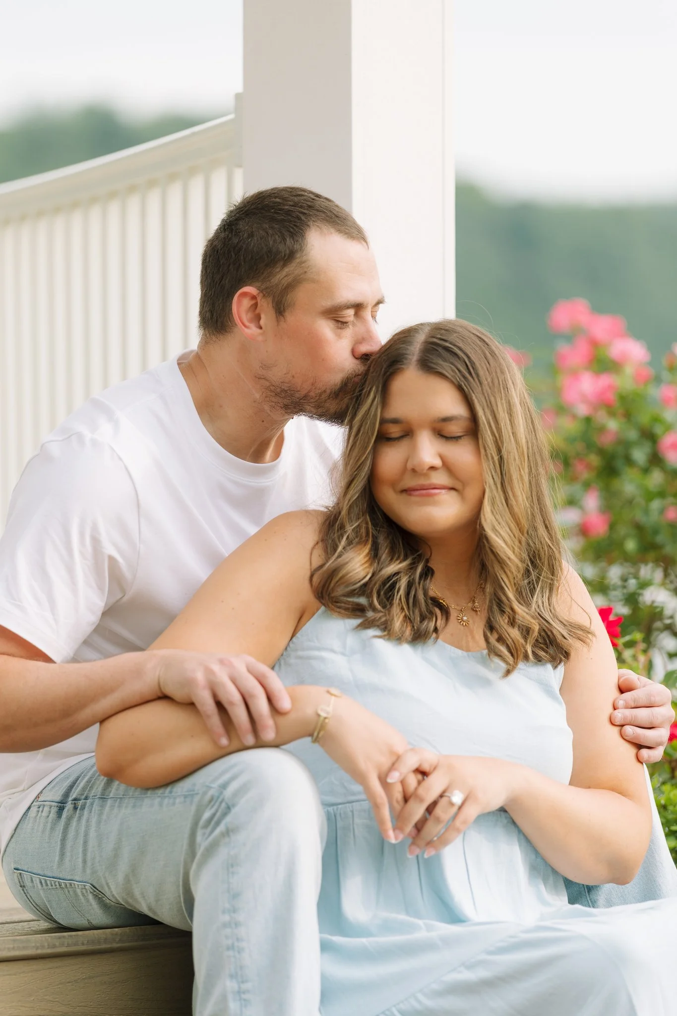 A couple sitting at a gazebo, embracing, for a engagement photo session in Tampa, FL.
