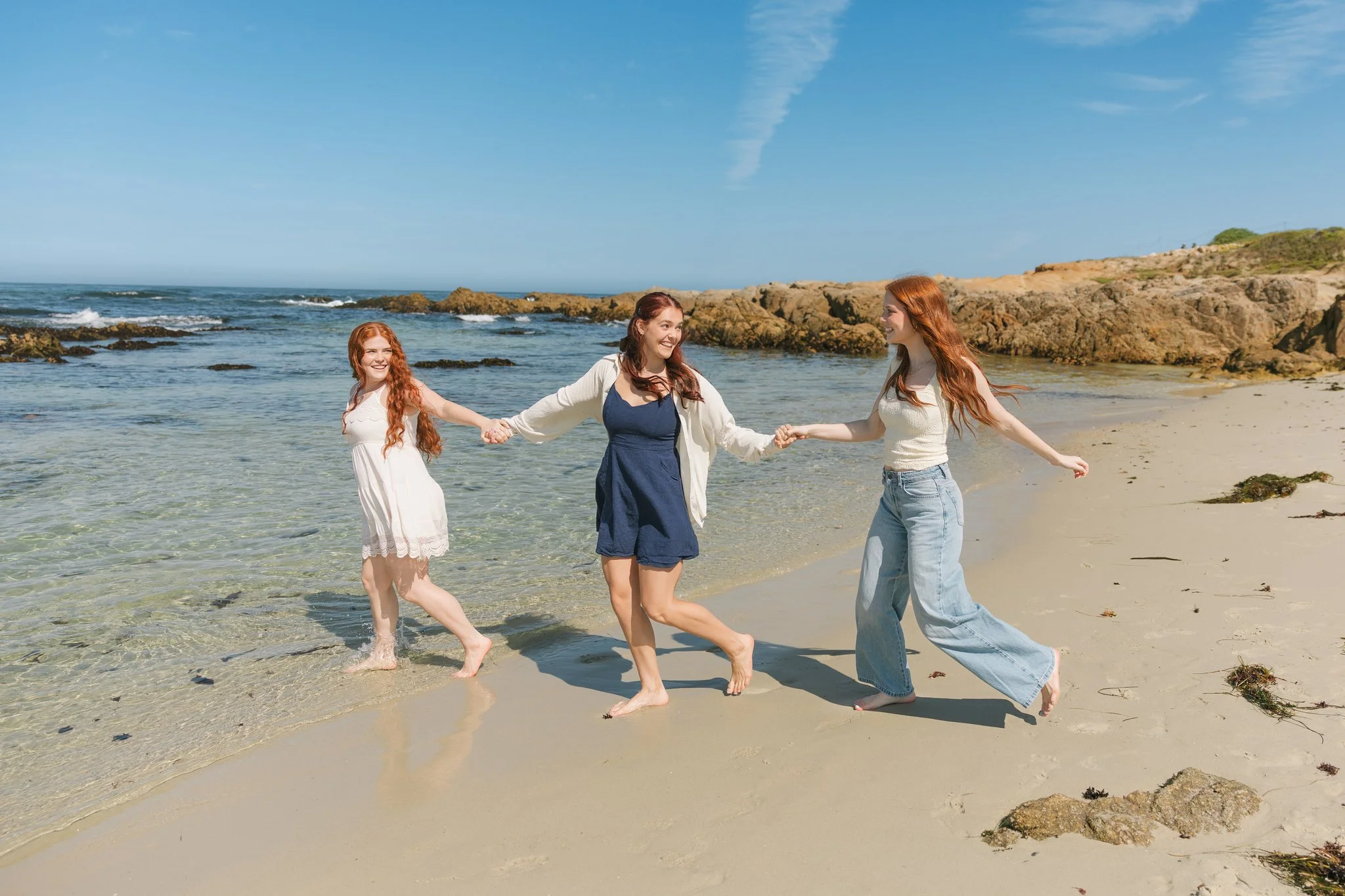 Family smiling and running on the beach during a Tampa Bay family photo session.