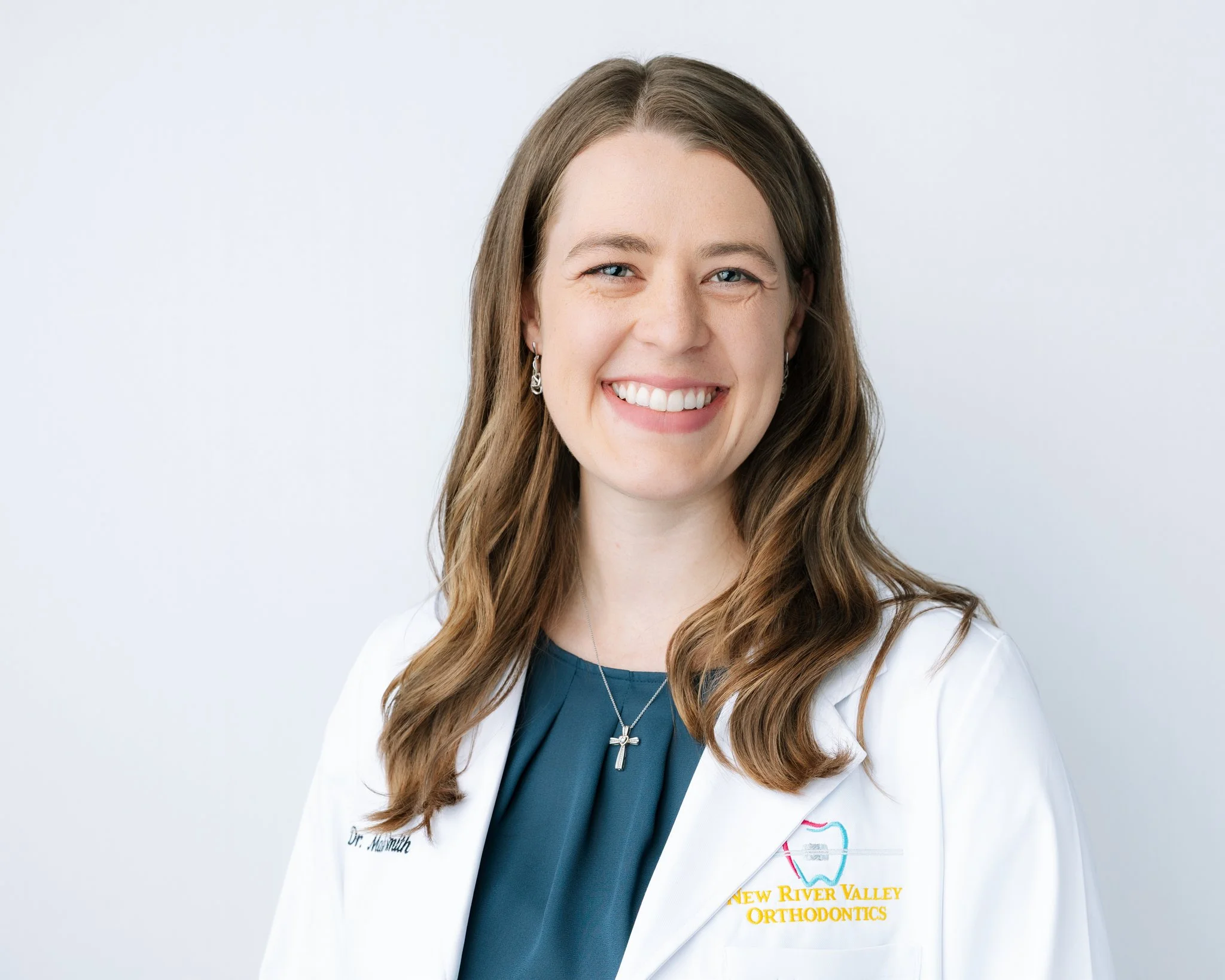 An orthodontist smiling for a headshot portrait during a commercial headshot portrait session in Tampa, FL.