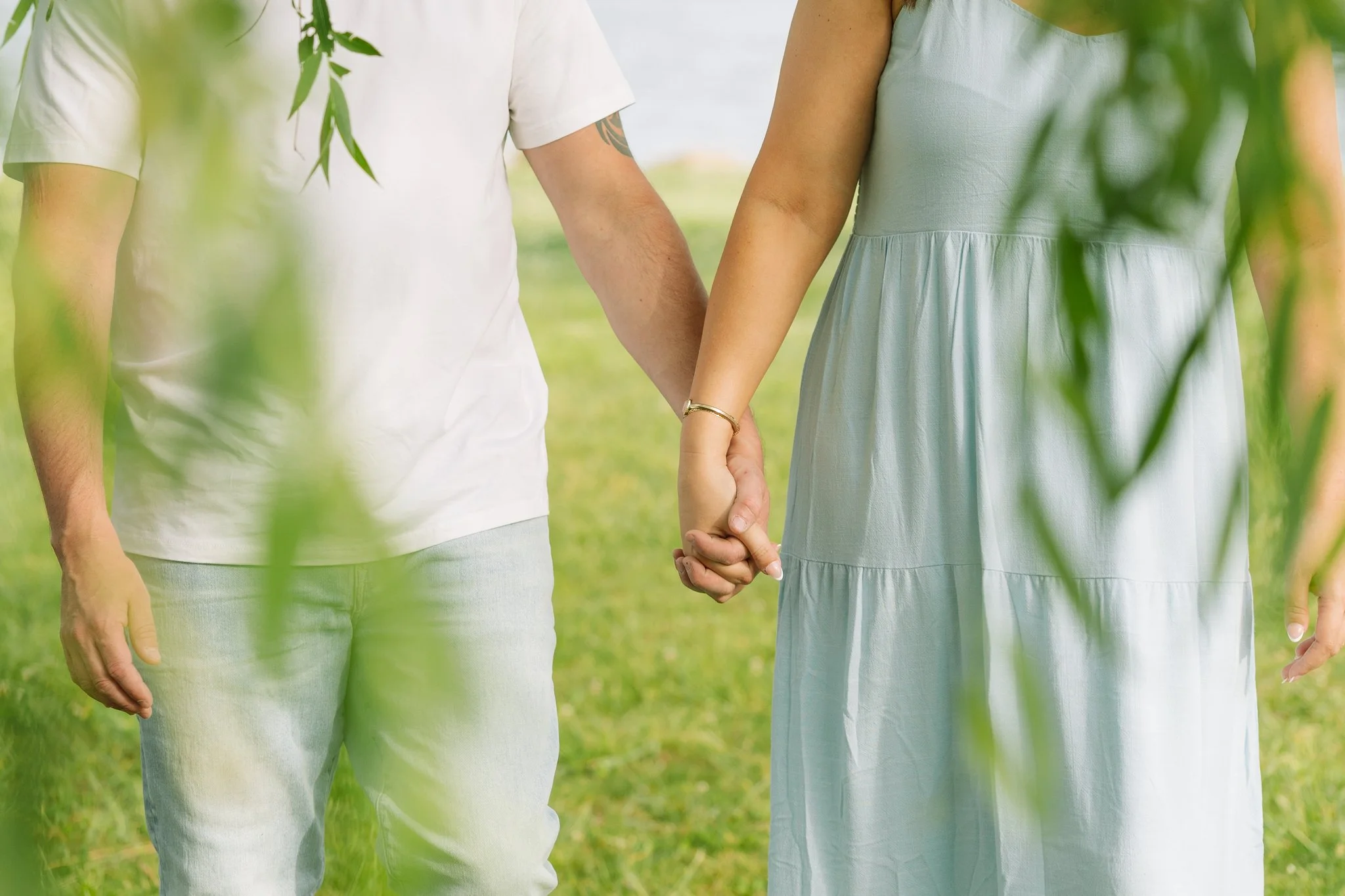 A couple holding hands, walking, for a Tampa, FL engagement session.